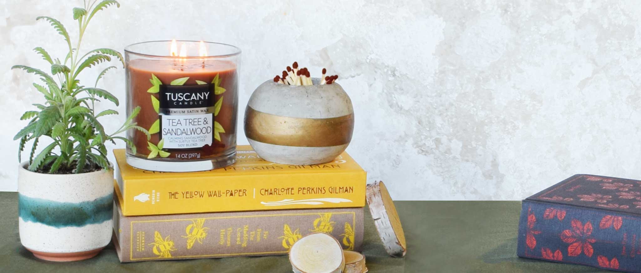 A candle sits on top of a wooden stump.