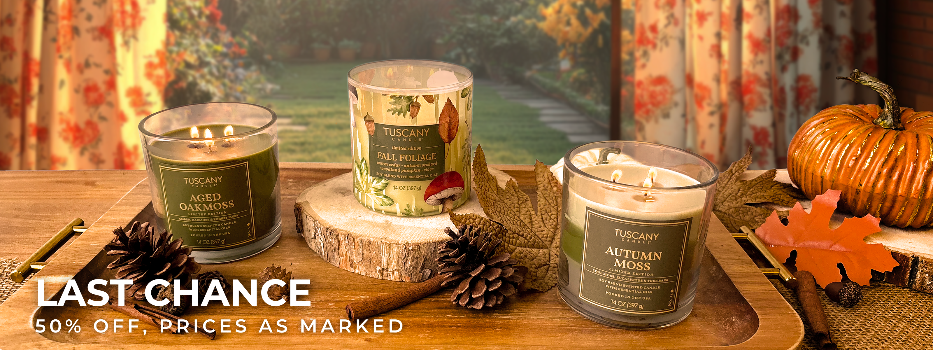 A cozy scene with a chair, a yellow pillow, a round table holding a lit candle, a pumpkin mug, two orange candles, and decorative pumpkins.