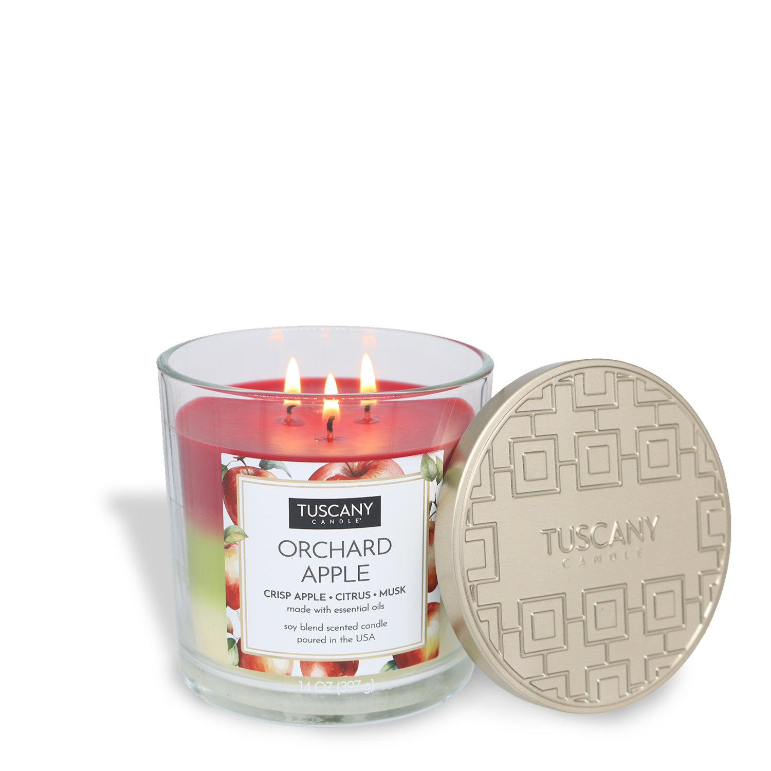 A Tuscany Candle® EVD Orchard Apple Long-Lasting Scented Jar Candle (14 oz) with three lit wicks in a glass jar, shown with a decorative beige lid placed beside it.