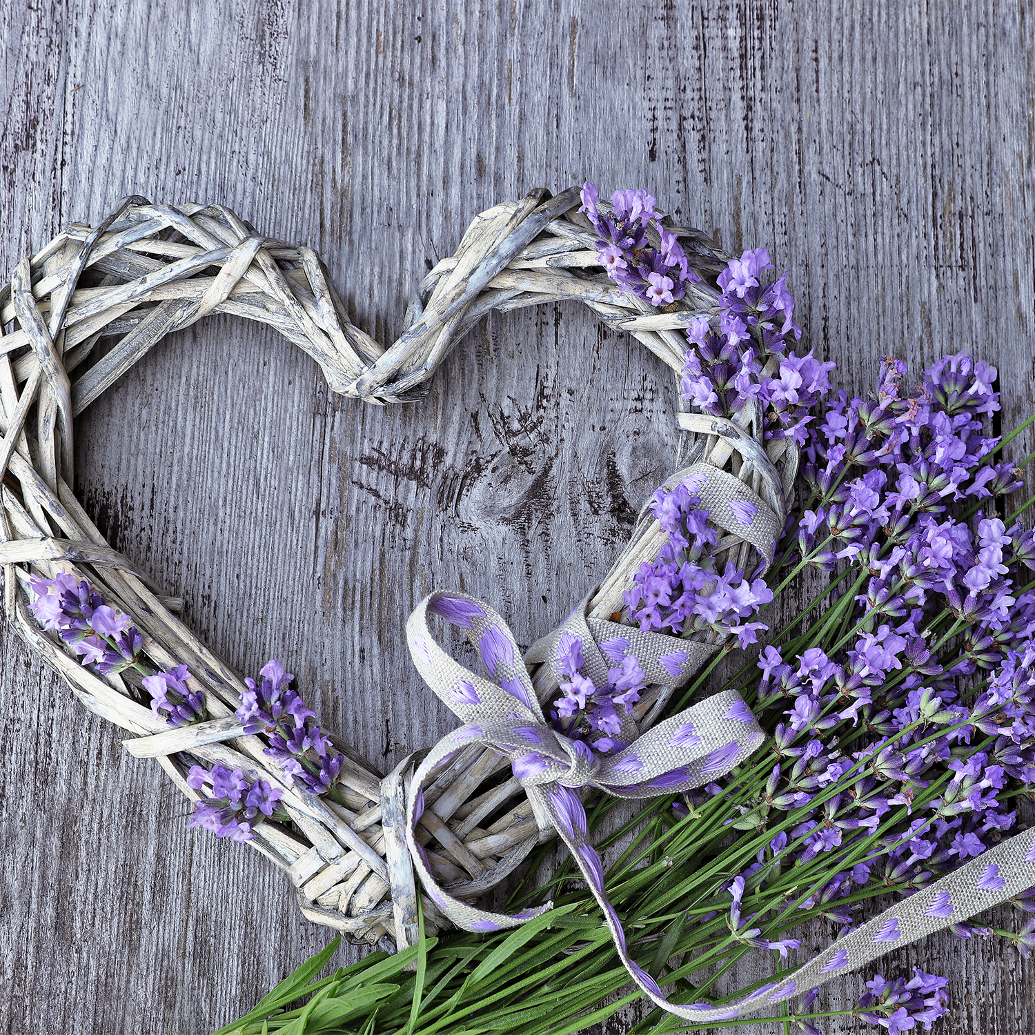 A Pride Heart Scented Tealights (9-Piece Set) arrangement of lavender flowers on a wooden table.