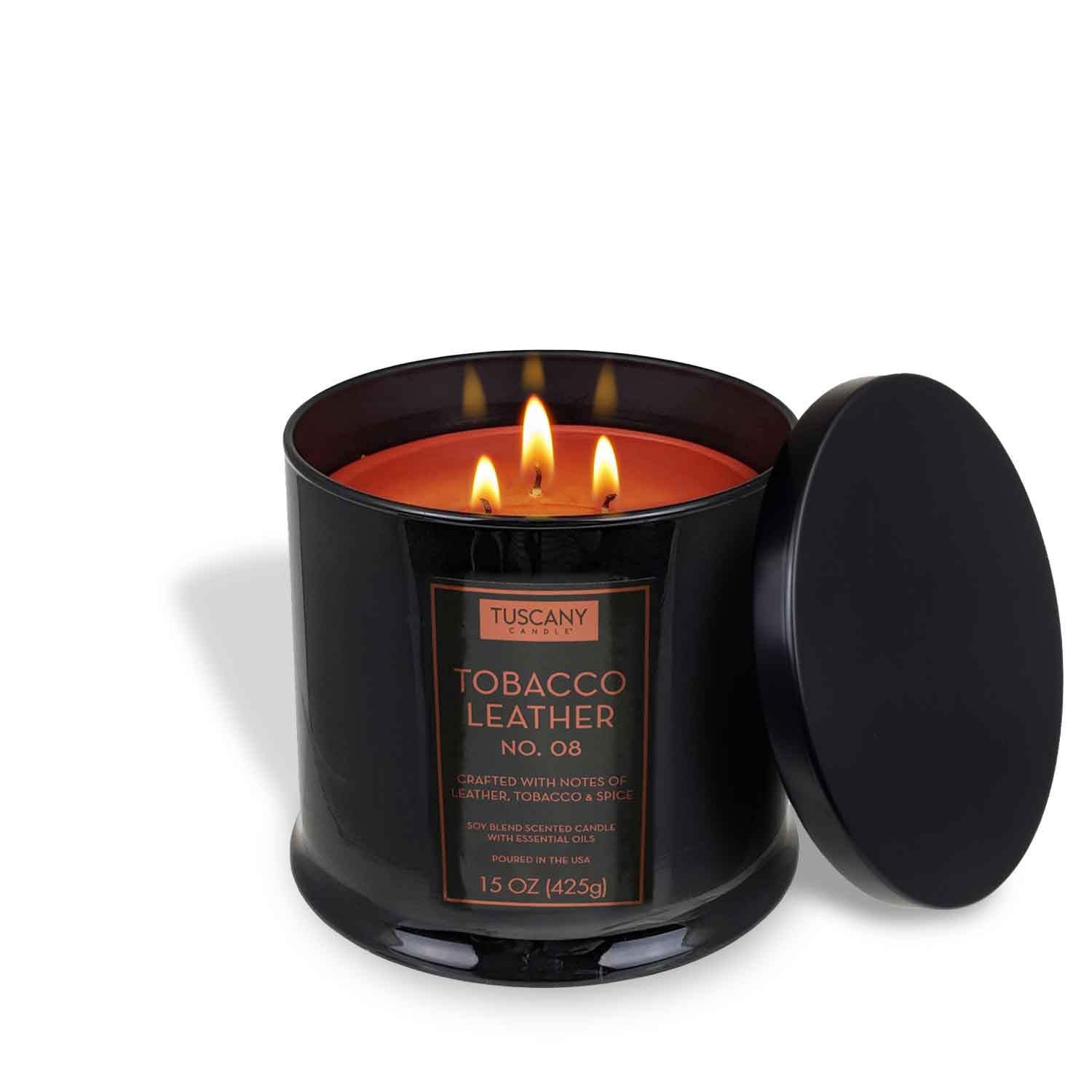 A black jar Tuscany Candle® EVD Tobacco Leather Scented Jar Candle (15 oz) from the Homme + Heritage Collection with three lit wicks and its lid beside it.
