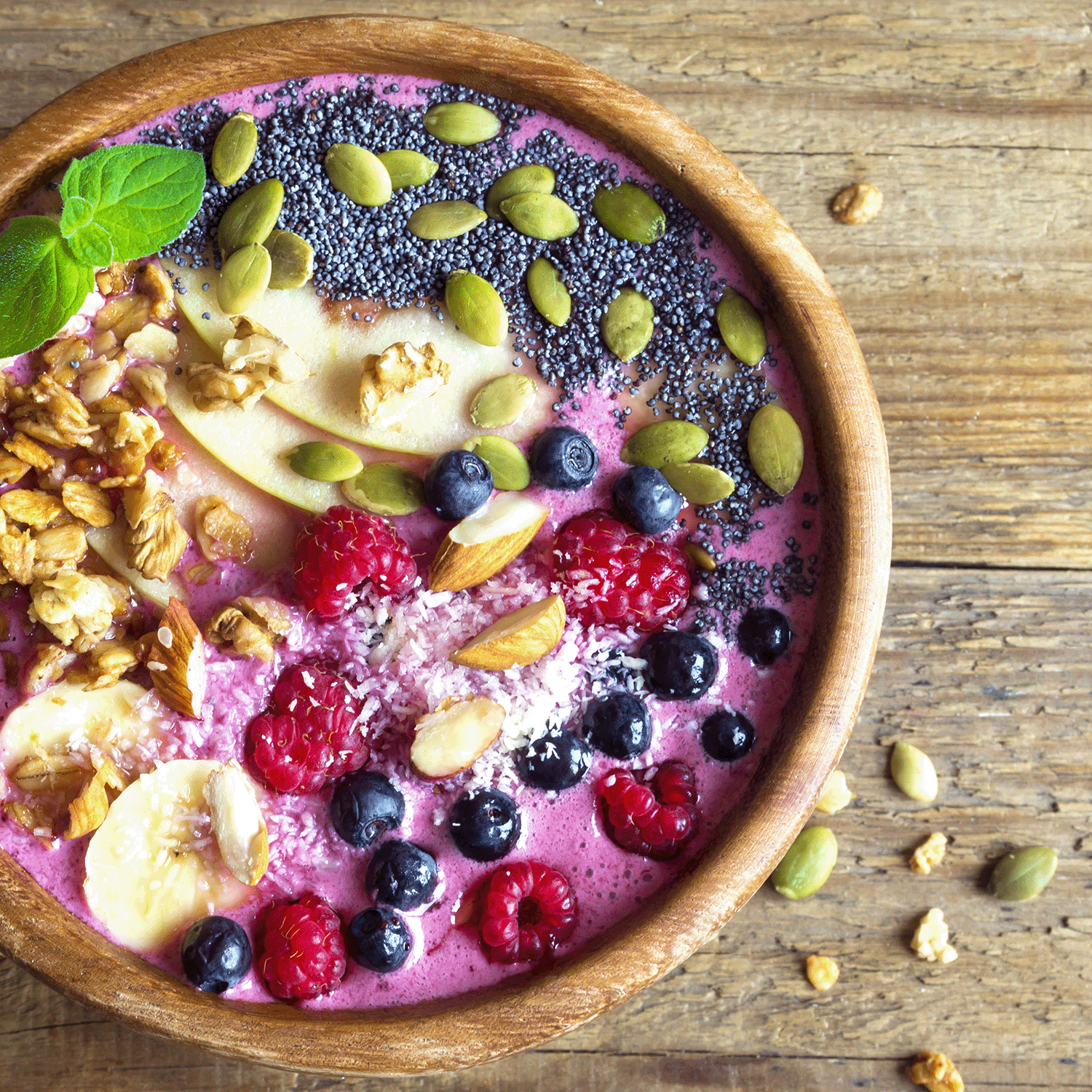 The Tuscany Candle® SEASONAL Forest Berry: Passionfruit Scented Summer Candle (18 oz) sits on a wooden table, its fresh aroma evoking summer fruits like raspberries, blueberries, and coconut.
