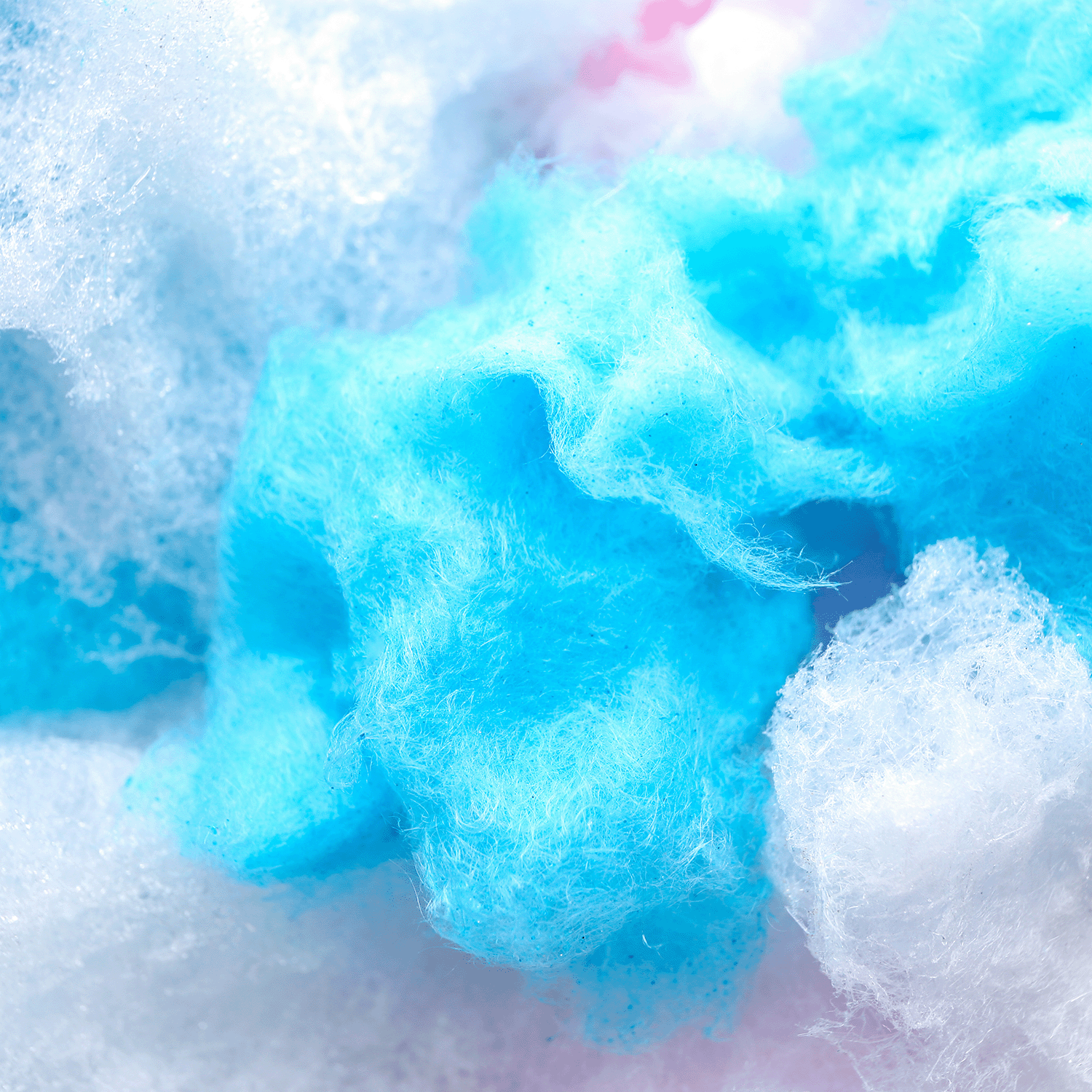 Close-up of Sour Berry Bliss: Blue Raspberry Scented Candle (12 oz) by Tuscany Candle® SEASONAL from the Gourmet Sorbet Collection, highlighting its fluffy blue and white look reminiscent of cotton candy.