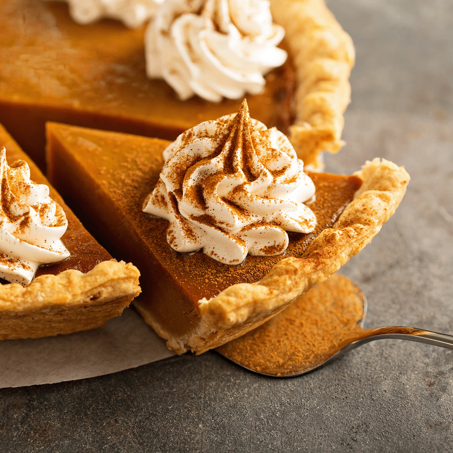 The warm aroma of Tuscany Candle® SEASONAL Harvest Pumpkin: Nutmeg & Clove Scented Fall Candle (18 oz) fills the air with cozy notes of pumpkin pie, whipped cream, and cinnamon like an inviting autumn home fragrance.