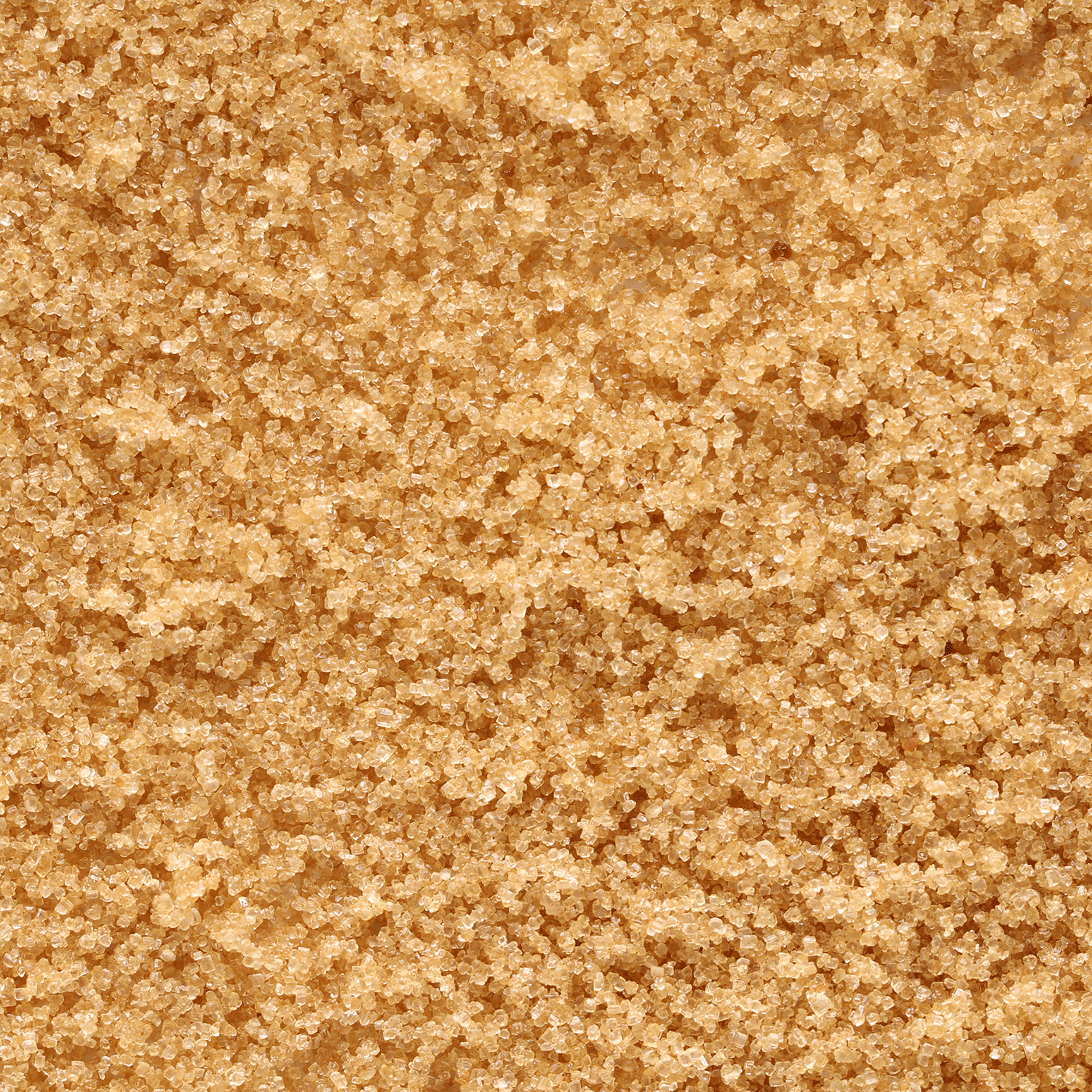 Close-up of coarse, light brown sugar crystals inspires Tuscany Candle® SEASONAL Ginger Spice Cake: Carrot & Vanilla Scented Fall Wax Melt (2.5 oz)—bringing cozy carrot cake fragrance to your home.