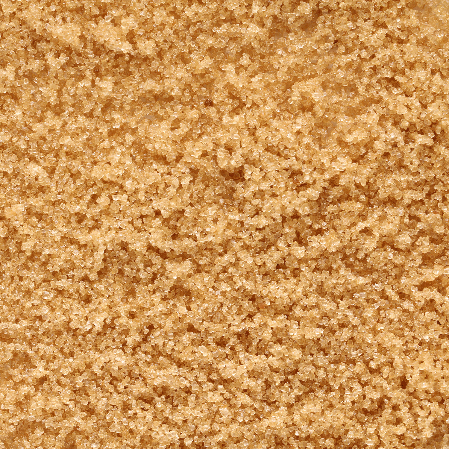 Close-up of granulated brown sugar highlights its texture and color, capturing the essence of fall baking in Tuscany Candle® SEASONAL Harvest Cookies: Brown Sugar & Vanilla Scented Fall Wax Melt (2.5 oz).