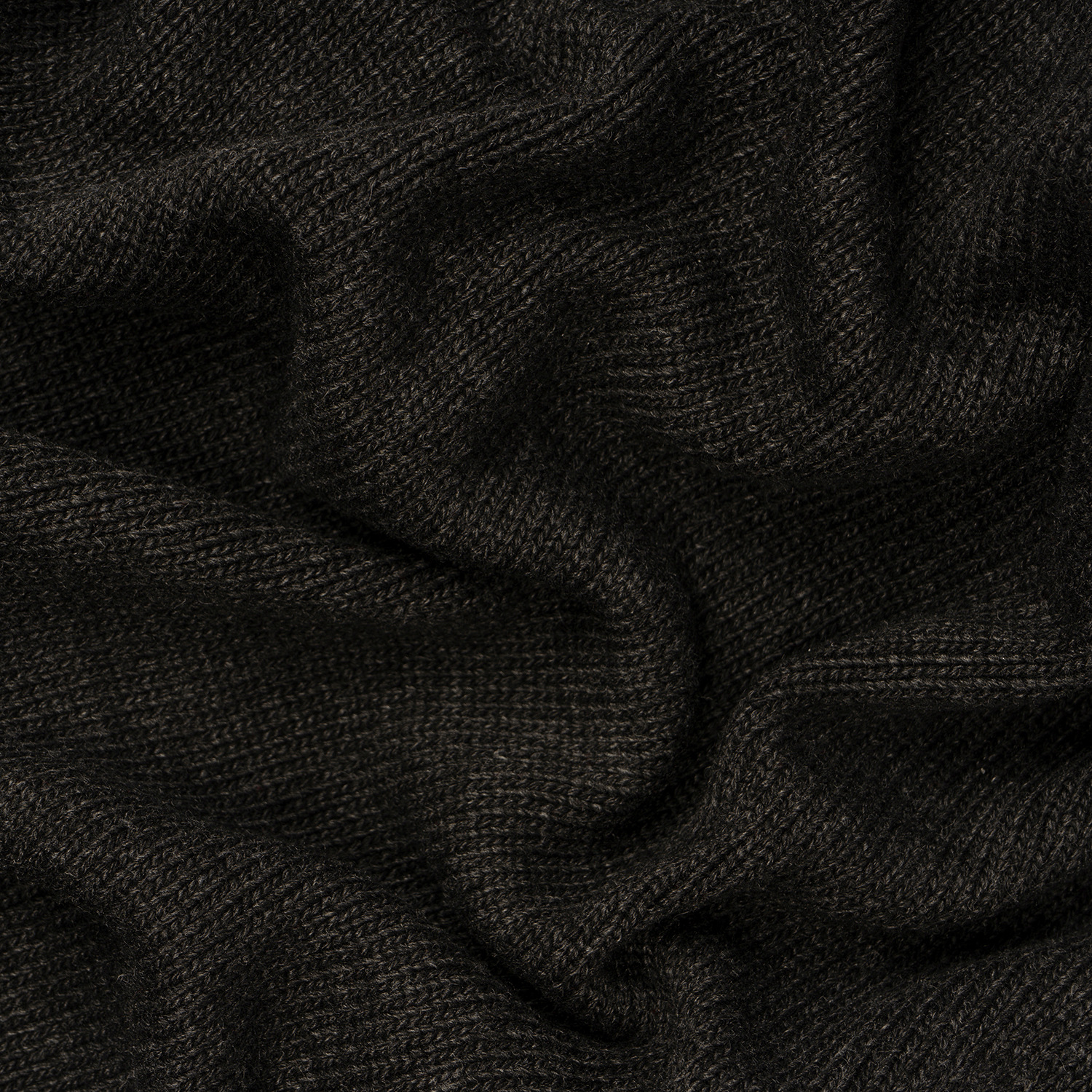 Close-up of dark brown knitted fabric with visible texture and gentle folds, evoking cozy evenings beside the Toil & Trouble: Sandalwood & Candied Plum Scented Halloween Candle (14 oz) from Tuscany Candle® SEASONAL.
