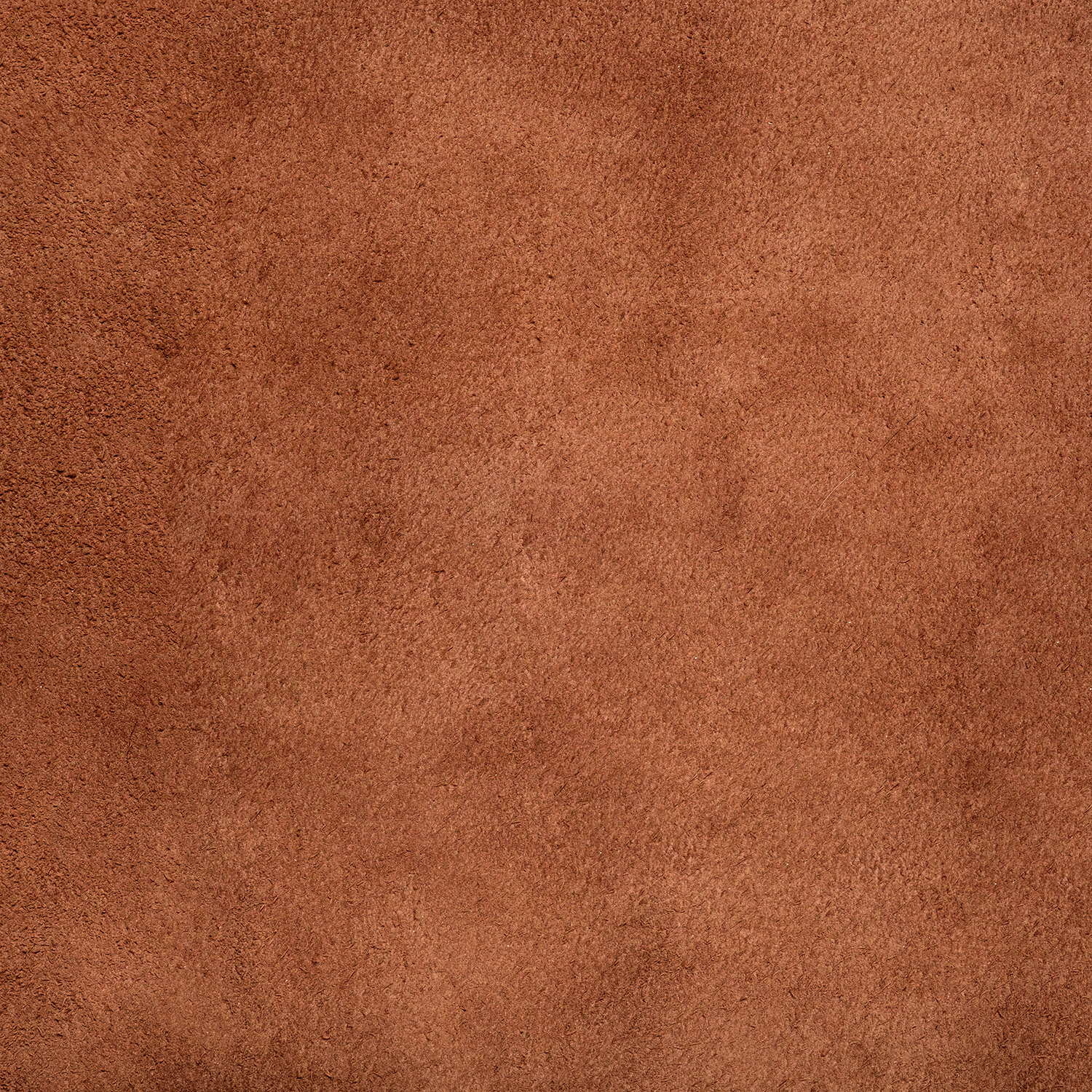 Close-up of the Tuscany Candle® SEASONAL Vintage Ski Lodge Scented Holiday Candle (14 oz), highlighting its soft, brown suede-like texture and vintage ski lodge-inspired surface.