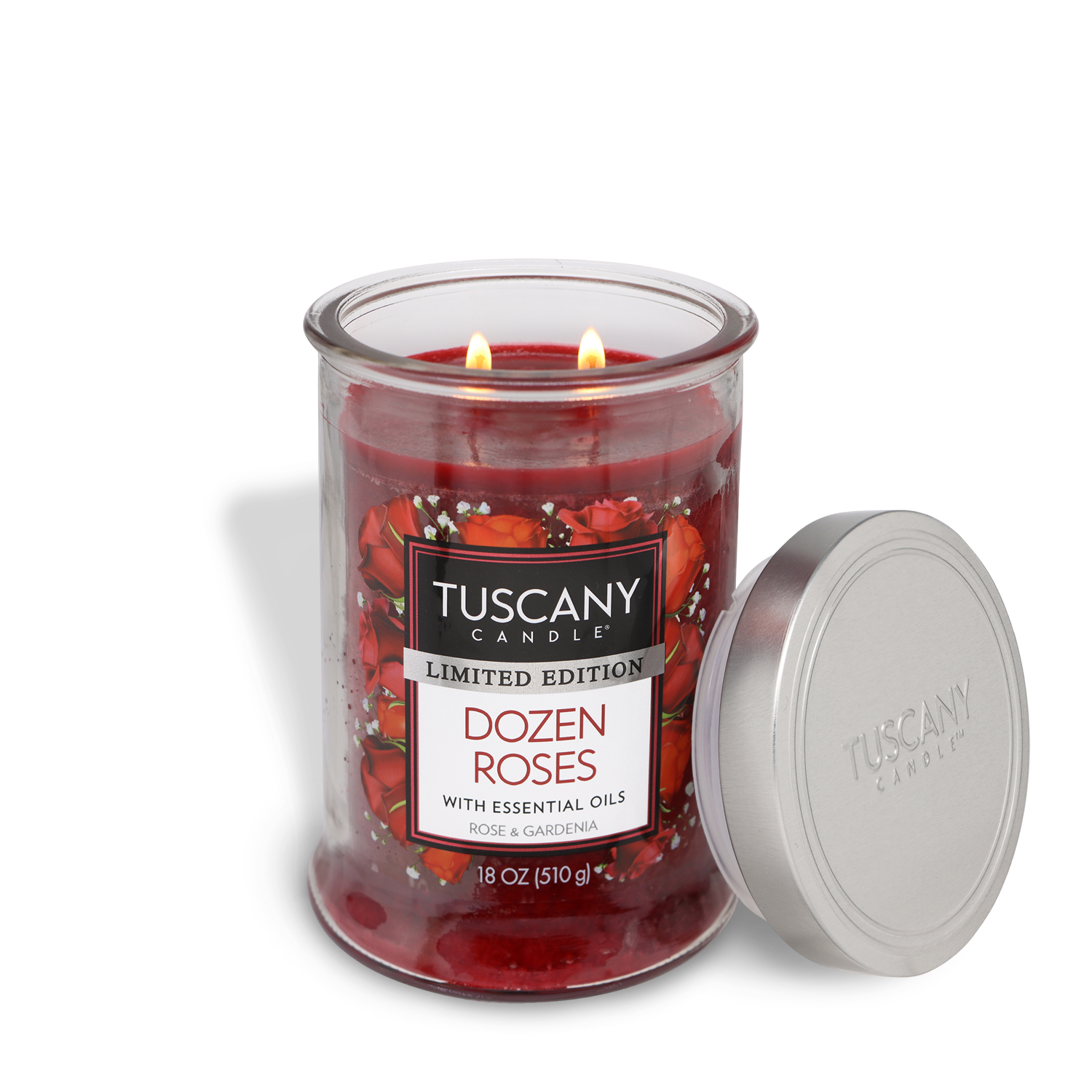 An 18 oz Tuscany Candle® SEASONAL "Dozen Roses: Rose & Gardenia Scented Valentine’s Candle" with red wax and rose accents is lit beside its silver lid.