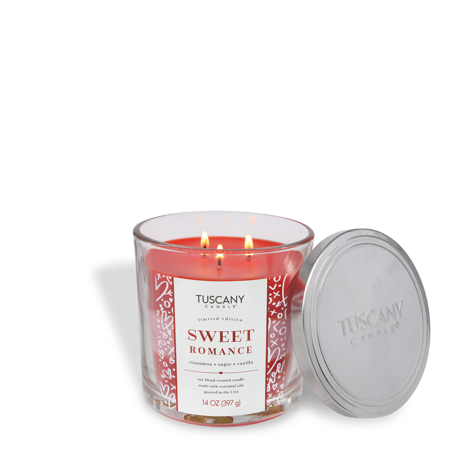 A red, three-wick Tuscany Candle® SEASONAL "Sweet Romance: Cinnamon & Sugar Scented Valentine's Candle" (14 oz) is pictured with the lid off beside the glass jar. The label highlights aromas of cinnamon, sugar, and vanilla.