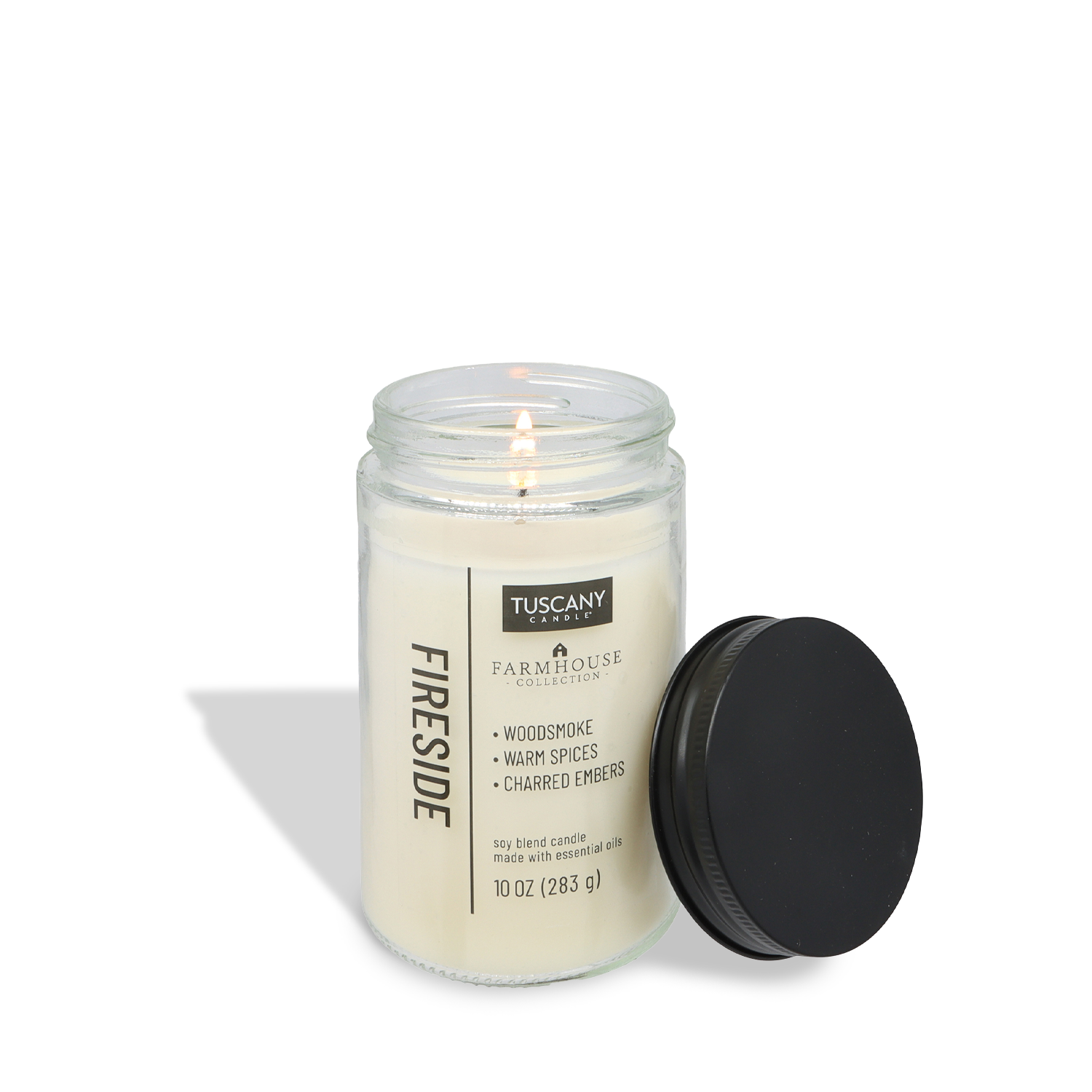 Create cozy farmhouse decor with the Tuscany Candle® EVD Fireside Scented Jar Candle (10 oz) from the Farmhouse Collection, featuring notes of woodsmoke, warm spices, and charred embers in a glass jar with a black lid.