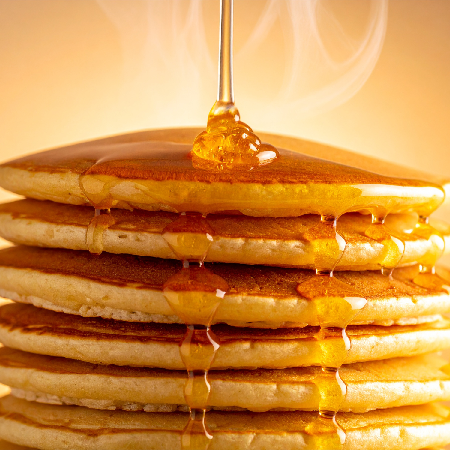 A stack of six pancakes with syrup sits beside a glowing Maple Bourbon Scented Jar Candle (10 oz) from the Tuscany Candle® EVD Farmhouse Collection, all set against a warm, inviting background.