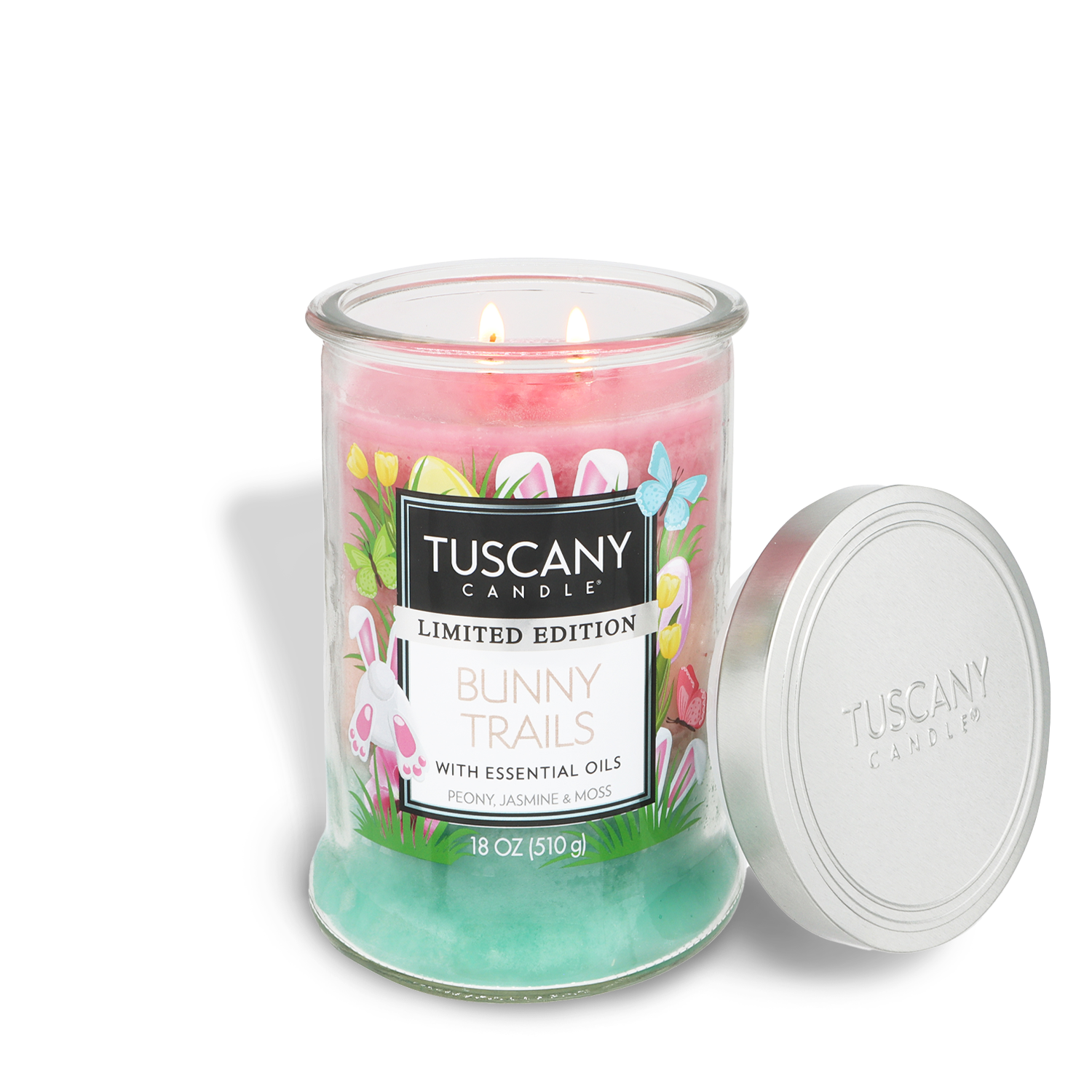 An 18 oz Tuscany Candle® Bunny Trails: Peony & Jasmine Scented Easter Candle in a glass jar with pink and green wax, a floral design, and the lid placed beside it.