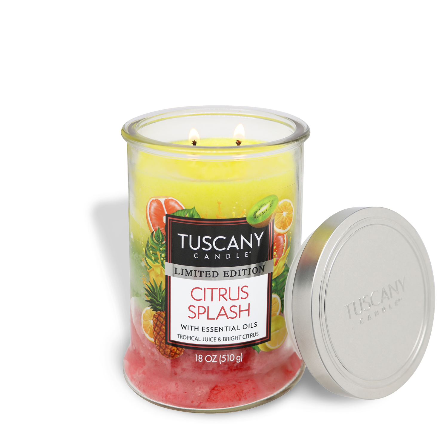 A Tuscany Candle® SEASONAL Citrus Splash: Tropical Juice & Bright Citrus Scented Spring Candle (18 oz) in a glass jar with a silver lid, featuring yellow and pink layers, is shown lit with two flames.
