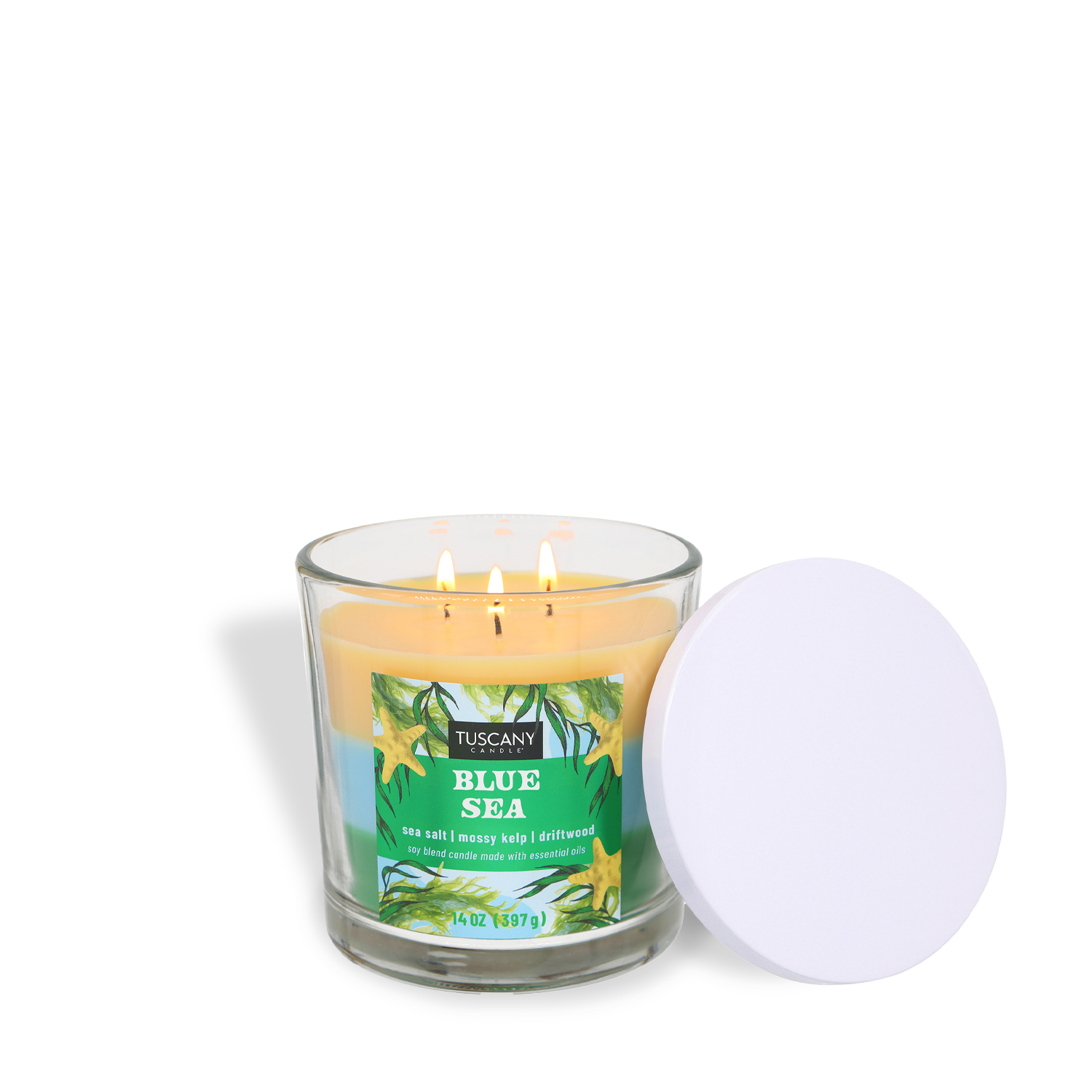 A lit Tuscany Candle® SEASONAL Blue Sea: Sea Salt & Kelp Scented Spring Candle (14 oz) in a glass jar with white lid and a floral label evokes an ocean-inspired fragrance, perfect for enhancing any room.