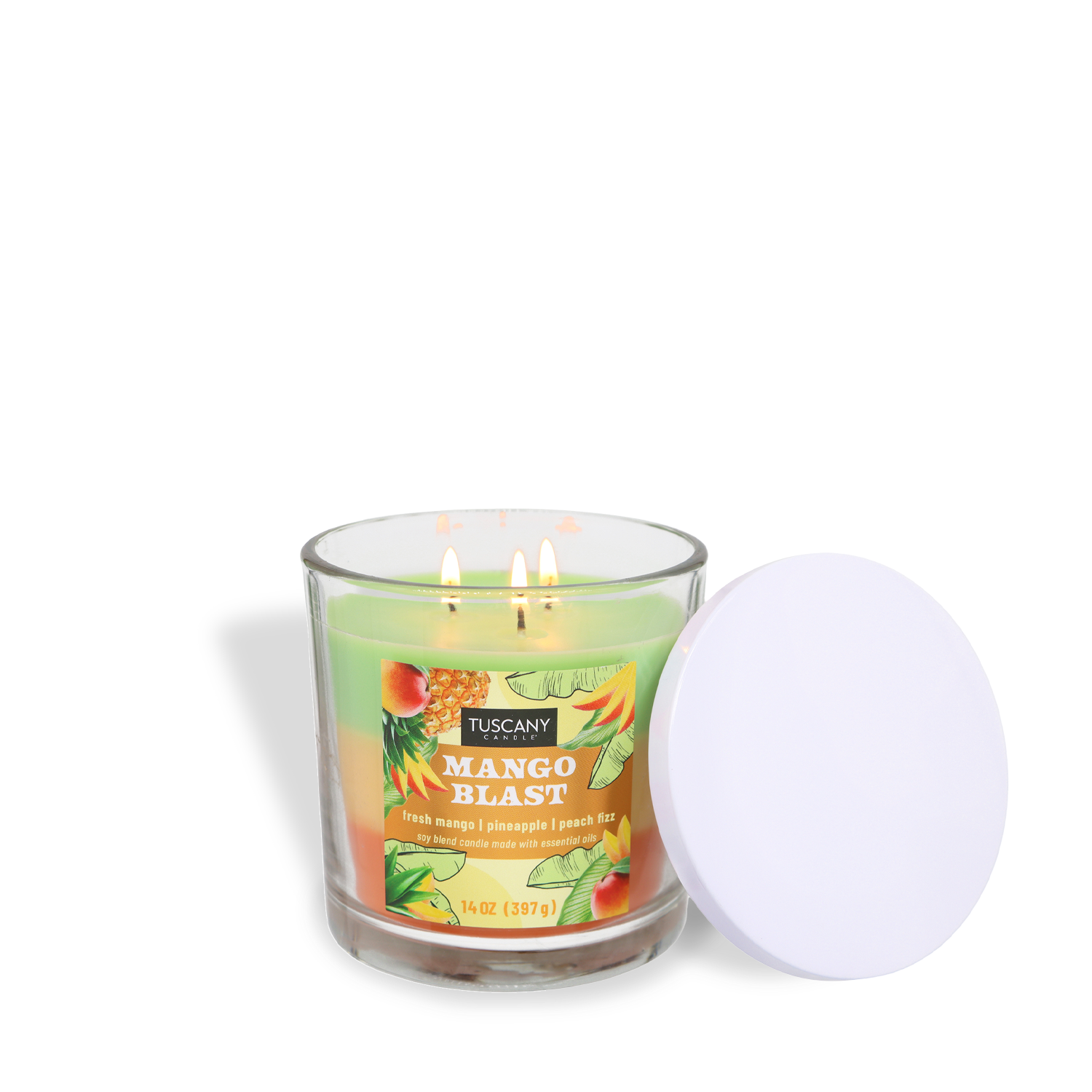 A lit Tuscany Candle® SEASONAL Mango Blast: Pineapple & Peach Scented Spring Candle (14 oz) in a glass jar with a white lid to the side. The label shows mango, pineapple, and peach, evoking a tropical spring aroma.