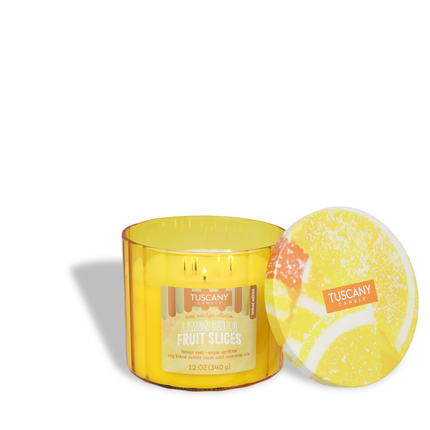 The Tuscany Candle® SEASONAL "Limoncello Fruit Slices: Meyer Lemon Scented Summer Candle" (12 oz) is lit, with its lid beside it, filling any space with a fresh citrus scent for summer vibes against a white background.