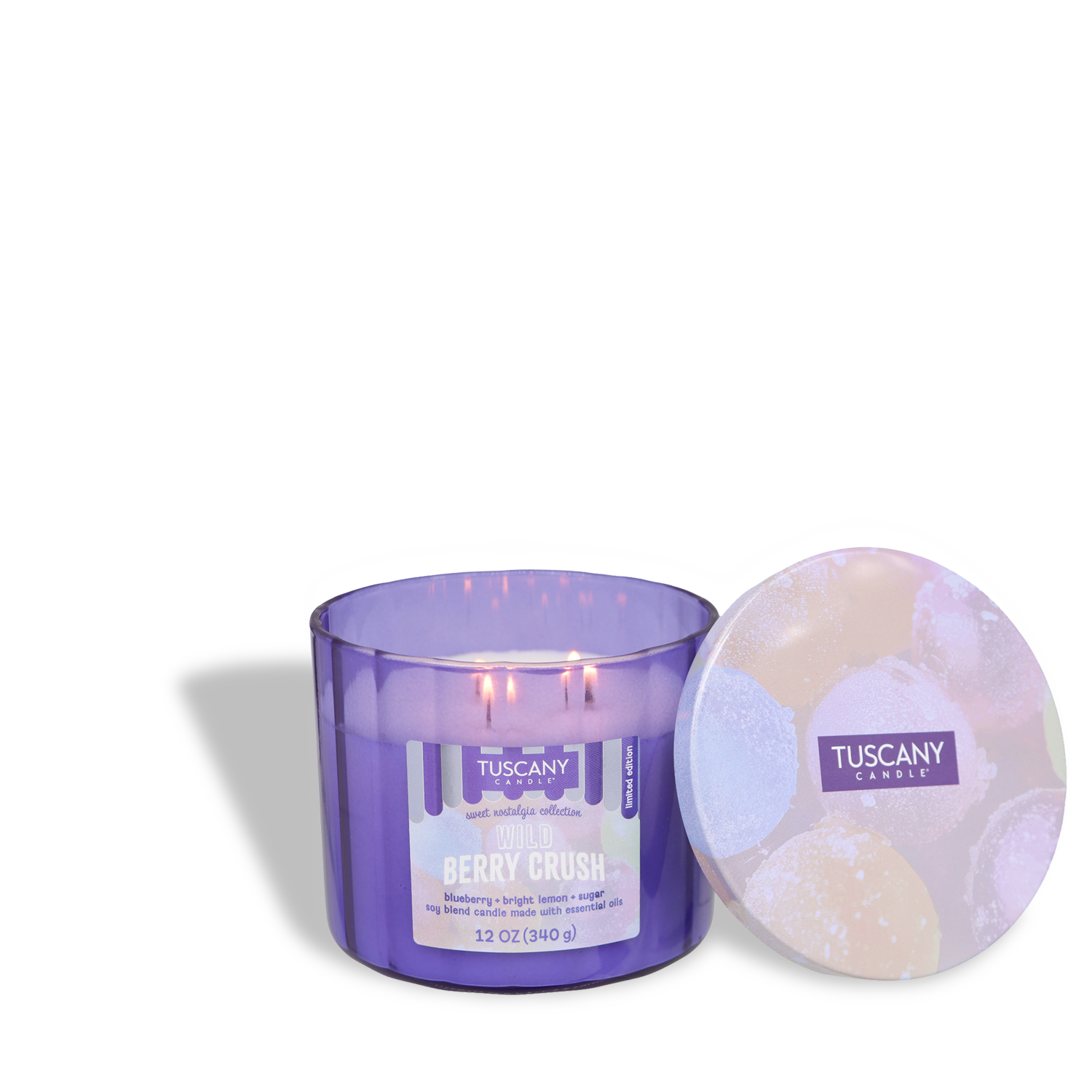 The Tuscany Candle® SEASONAL "Wild Berry Crush: Blueberry & Lemon Scented Summer Candle" (12 oz) features a purple jar with three lit wicks and a fruit-illustrated lid placed beside the vibrant, summery candle.
