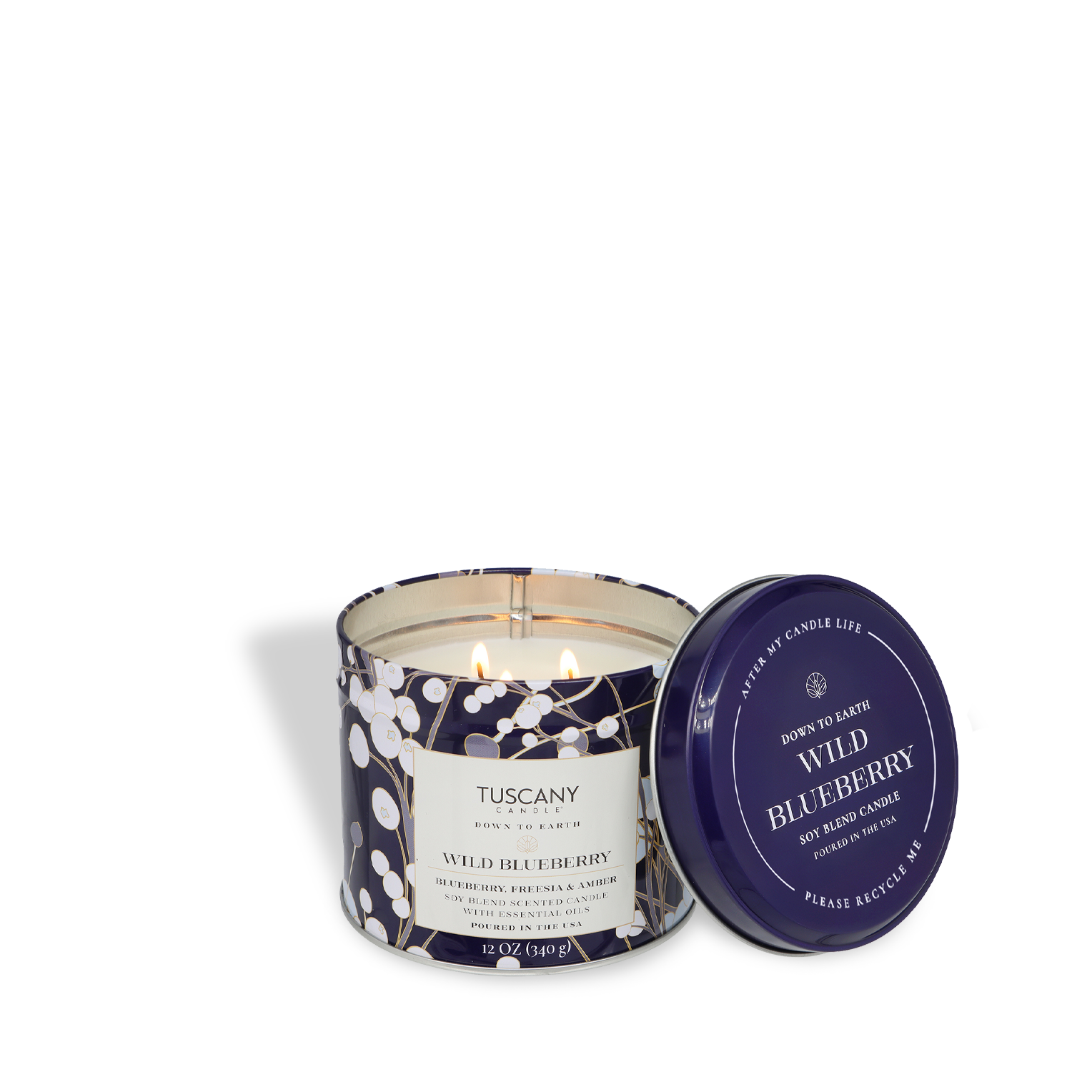 A lit Tuscany Candle® SEASONAL "Wild Blueberry: Freesia & Amber" 12 oz tin from the Down to Earth Collection rests with its lid beside it on a white surface, evoking the fresh scent of spring.