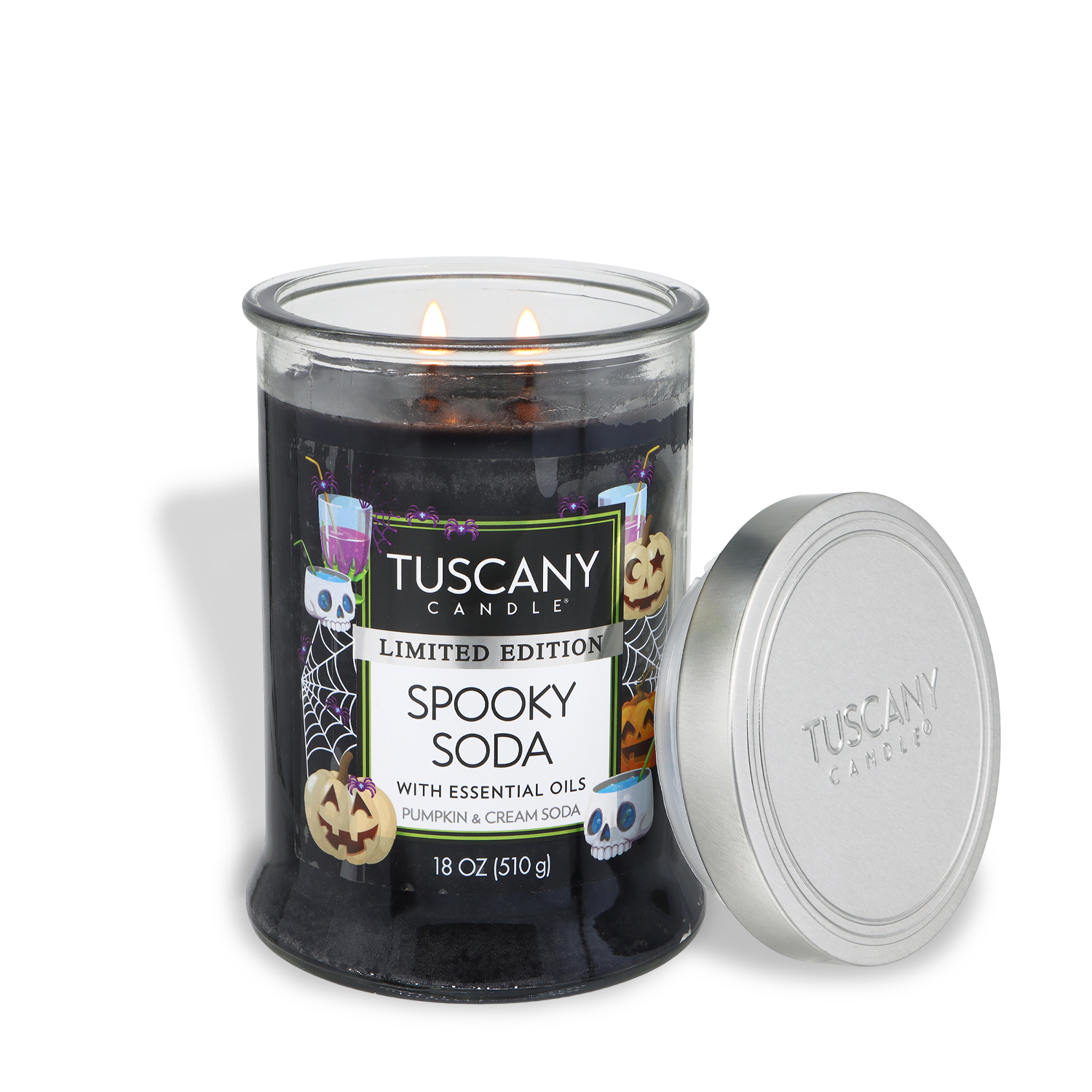 A lit black candle labeled “Spooky Soda: Pumpkin & Cream Soda Scented Halloween Candle (18 oz)” by Tuscany Candle® SEASONAL, featuring Halloween-themed graphics and a silver lid resting beside it.