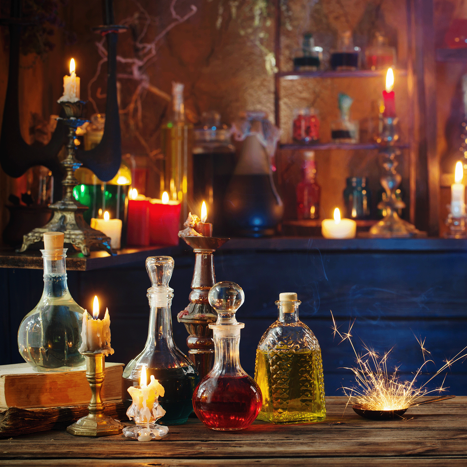 On a wooden table illuminated by the glow of lit candles and sparkling lights, Cauldron Boil: Smoked Cherry & White Woods Scented Halloween Candles from Tuscany Candle® SEASONAL (18 oz) are arranged among glass bottles filled with vibrant liquids; additional candles and bottles line the shelves in the background.