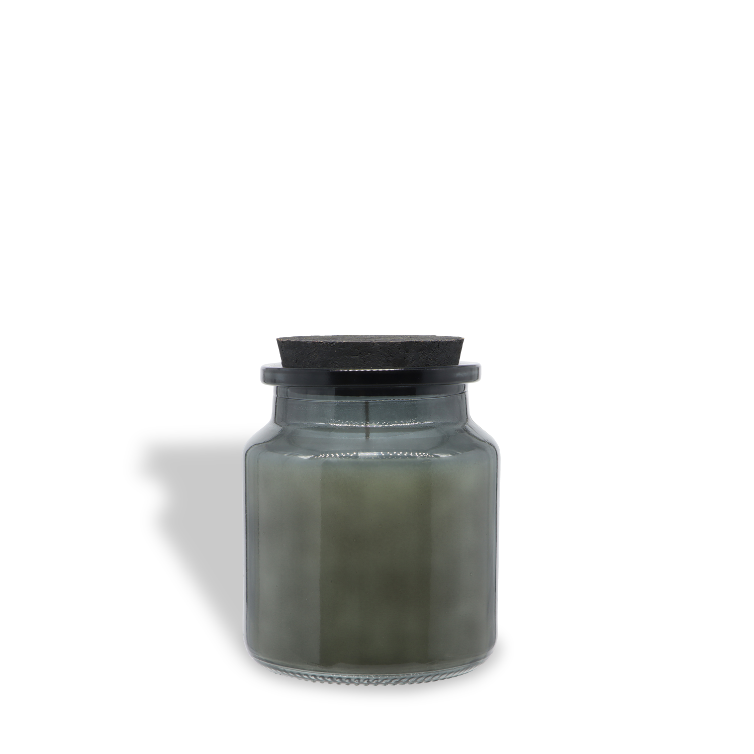 A clear glass jar with a dark lid holds the Batroot Tonic: Wildberries & Cedarwood Scented Halloween Candle (16 oz) by Tuscany Candle® SEASONAL, its grayish wax casting a shadow on a white background.