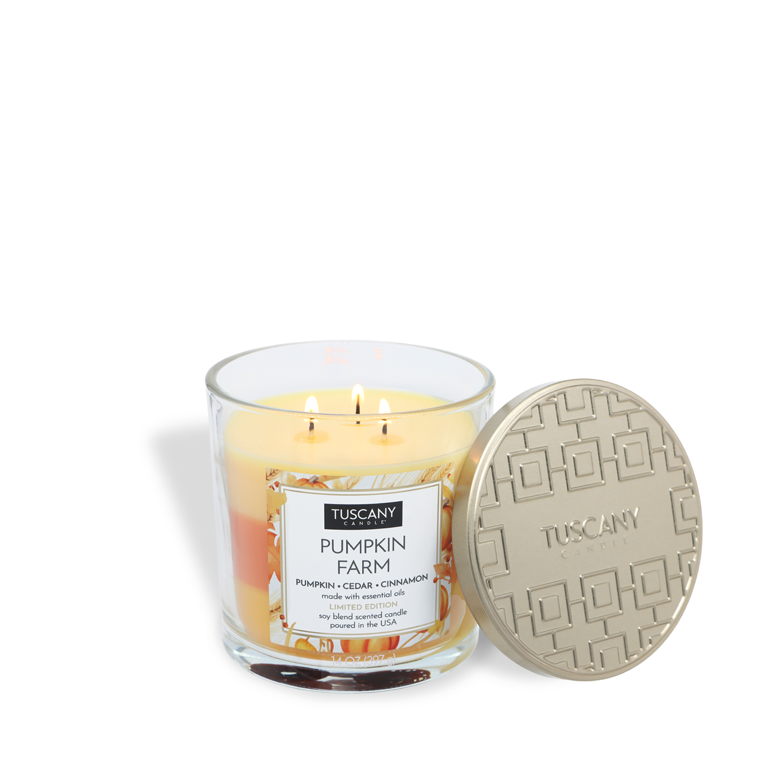 A Tuscany Candle® SEASONAL Pumpkin Farm: Cedar & Cinnamon Scented Fall Candle (14 oz), orange and yellow with three wicks, sits next to its embossed gold lid.