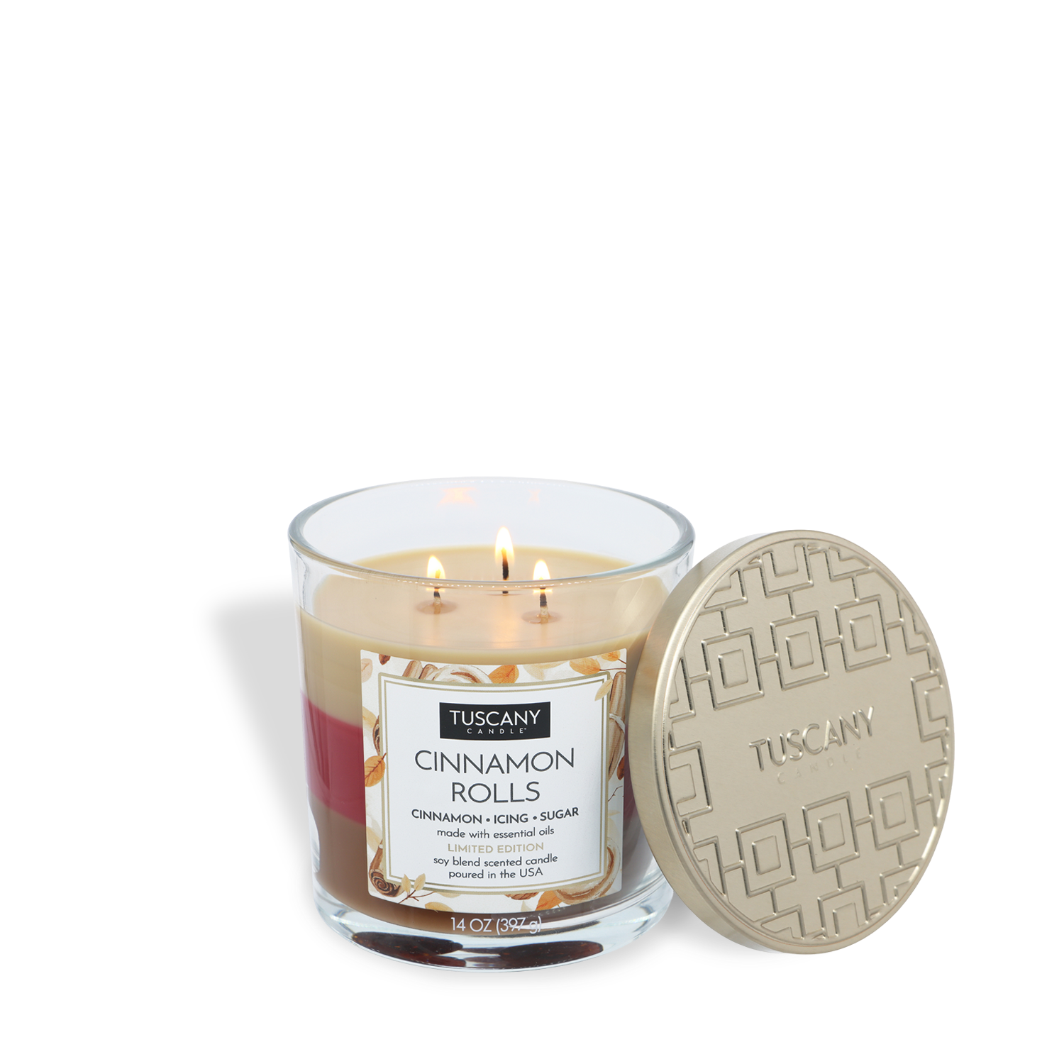 A Tuscany Candle® SEASONAL Cinnamon Rolls: Icing & Sugar Scented Fall Candle (14 oz) with three lit wicks is shown next to its textured, gold-colored lid resting on its side.