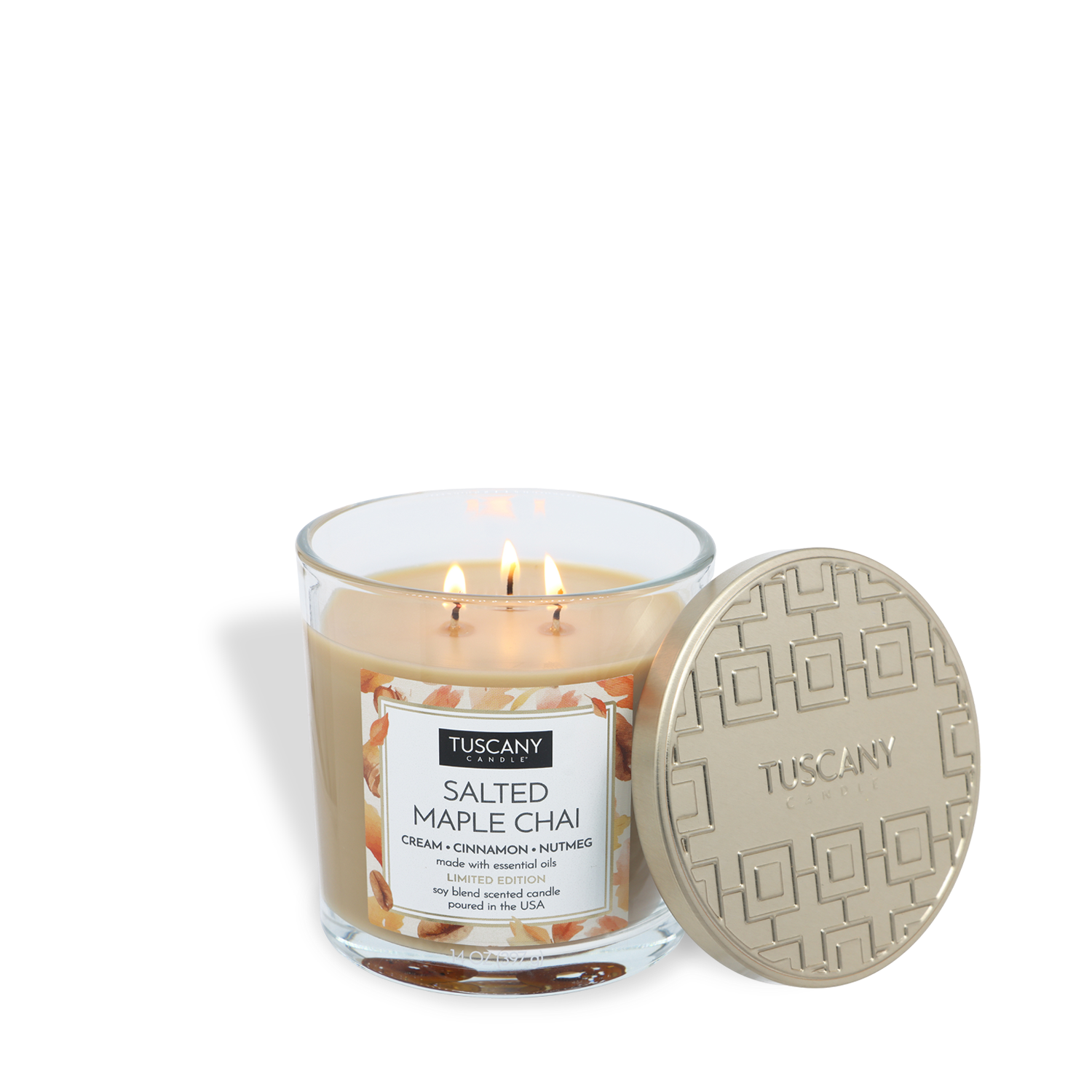 A Tuscany Candle® SEASONAL Salted Maple Chai: Cream & Cinnamon Scented Fall Candle (14 oz) sits in a glass jar with a beige decorative lid beside it.