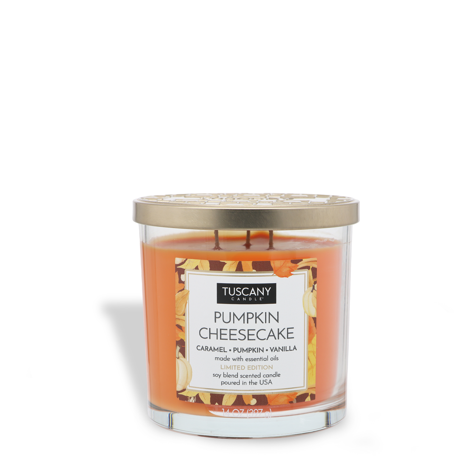 The Tuscany Candle® SEASONAL "Pumpkin Cheesecake: Caramel & Vanilla Scented Fall Candle" (14 oz) features a glass jar with a gold lid, orange wax, and pumpkin-themed decor on the label.