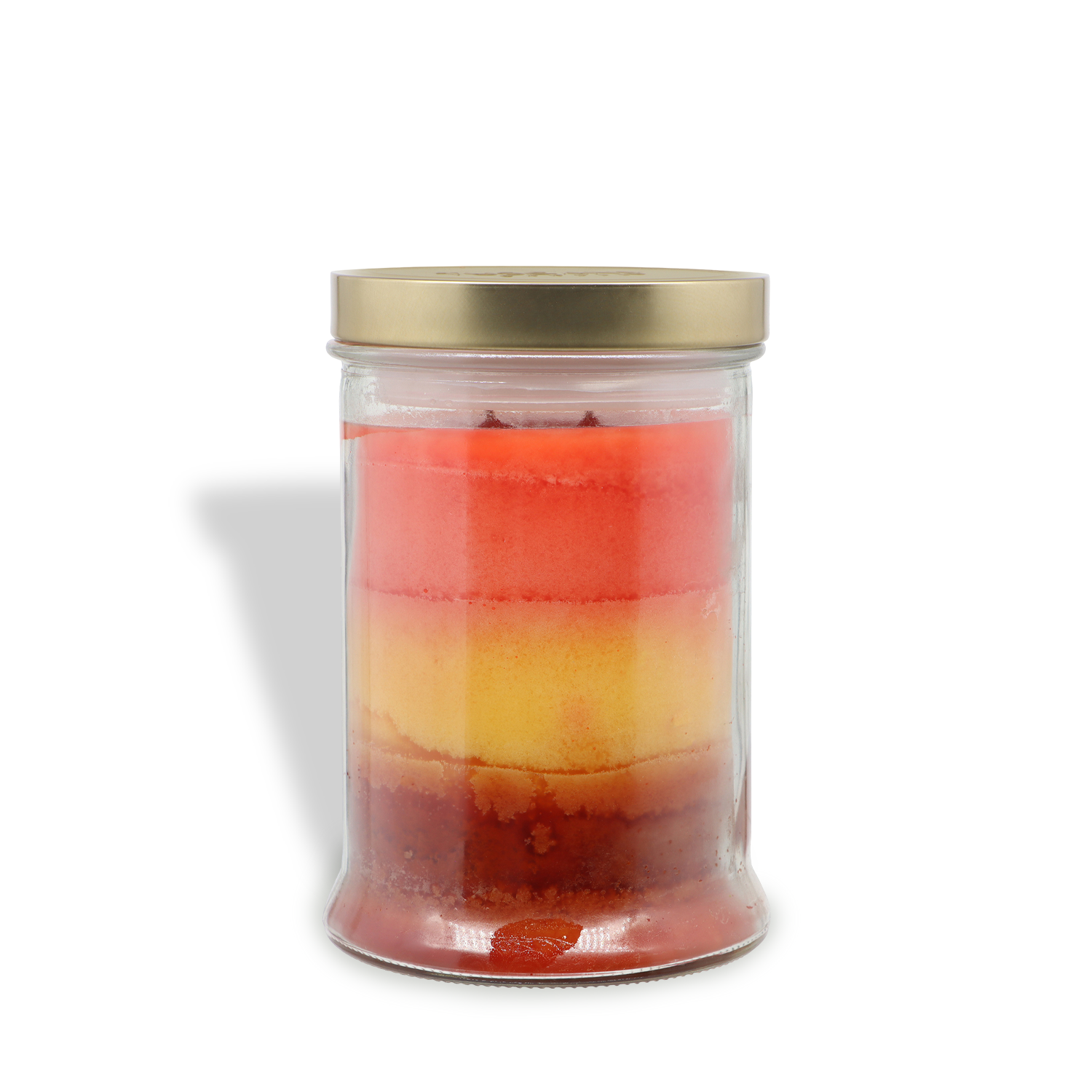 An 18 oz glass jar with a gold lid holds Tuscany Candle® SEASONAL's Harvest Pumpkin: Pumpkin & Autumn Spices scented fall candle, featuring layered red, yellow, and orange wax, shown against a white background.
