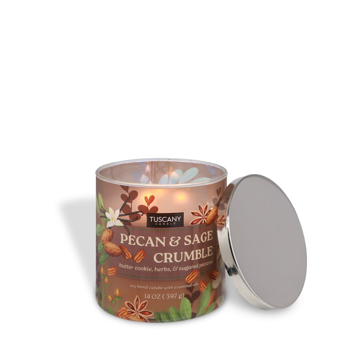 A lit Tuscany Candle® SEASONAL Pecan & Sage Crumble: Butter Cookie & Herbs scented fall candle (14 oz) sits with its silver lid beside it on a white background.