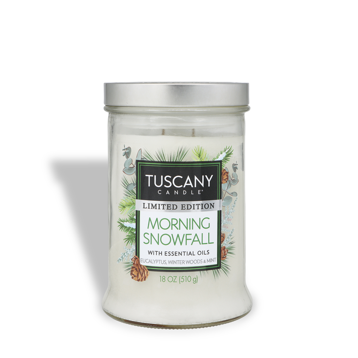 Tuscany Candle® SEASONAL Morning Snowfall: Eucalyptus & Winter Woods Scented Holiday Candle (18 oz) in a glass jar with a silver lid, decorated with pine branches, pinecones, and eucalyptus leaves.