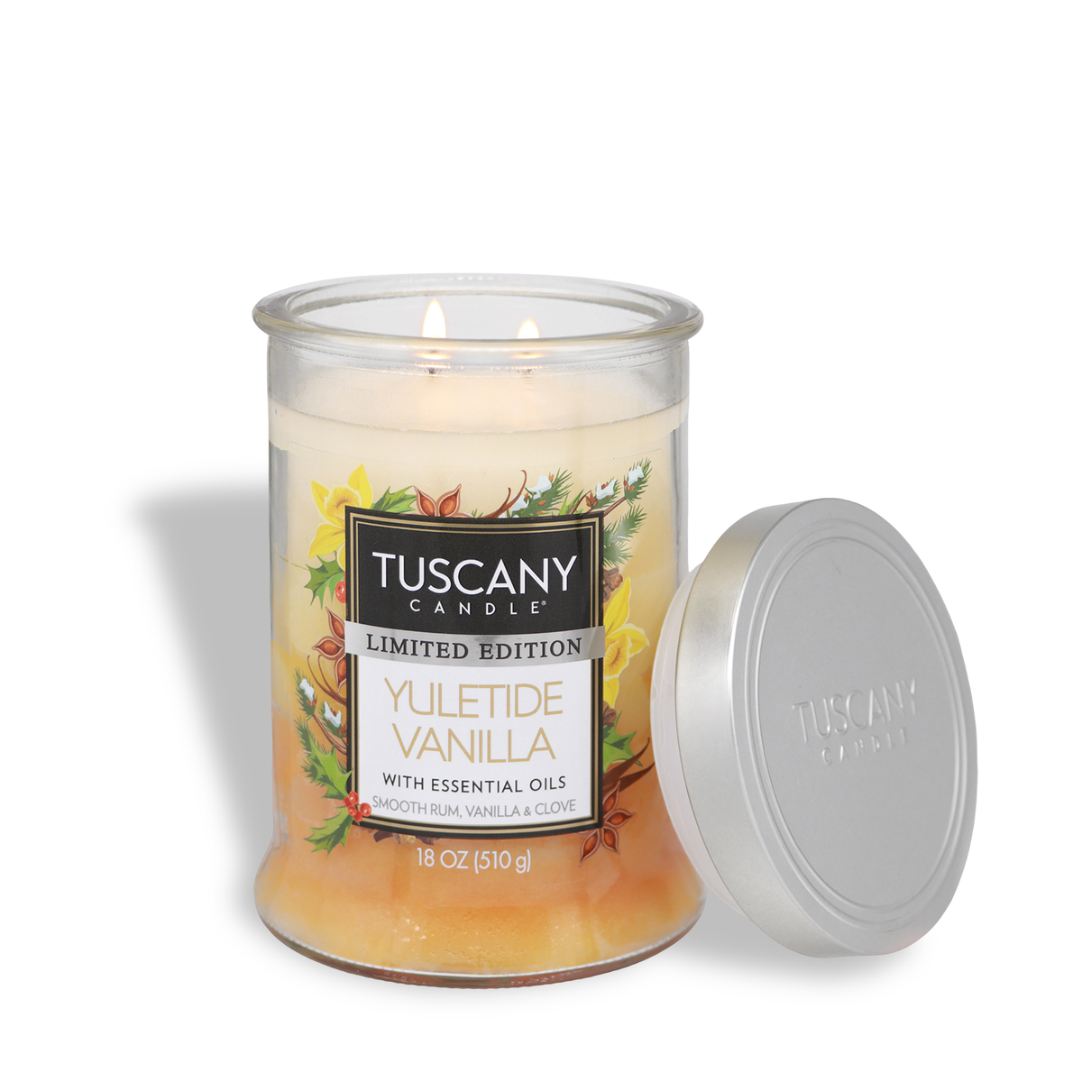 A lit two-wick Yuletide Vanilla: Smooth Rum & Clove Scented Holiday Candle (18 oz) in a glass jar with its silver lid sitting beside it.