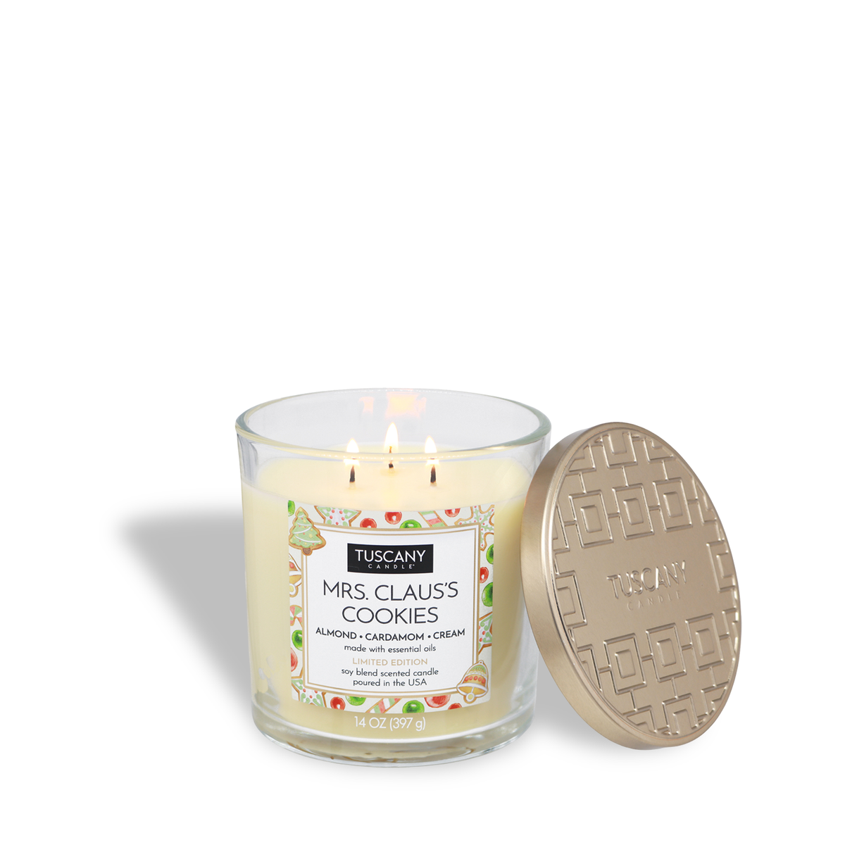 A Tuscany Candle® SEASONAL Mrs. Claus’s Cookies: Almond & Cardamom Scented Holiday Candle (14 oz) in a glass jar with a gold lid, featuring a label decorated with cookies.