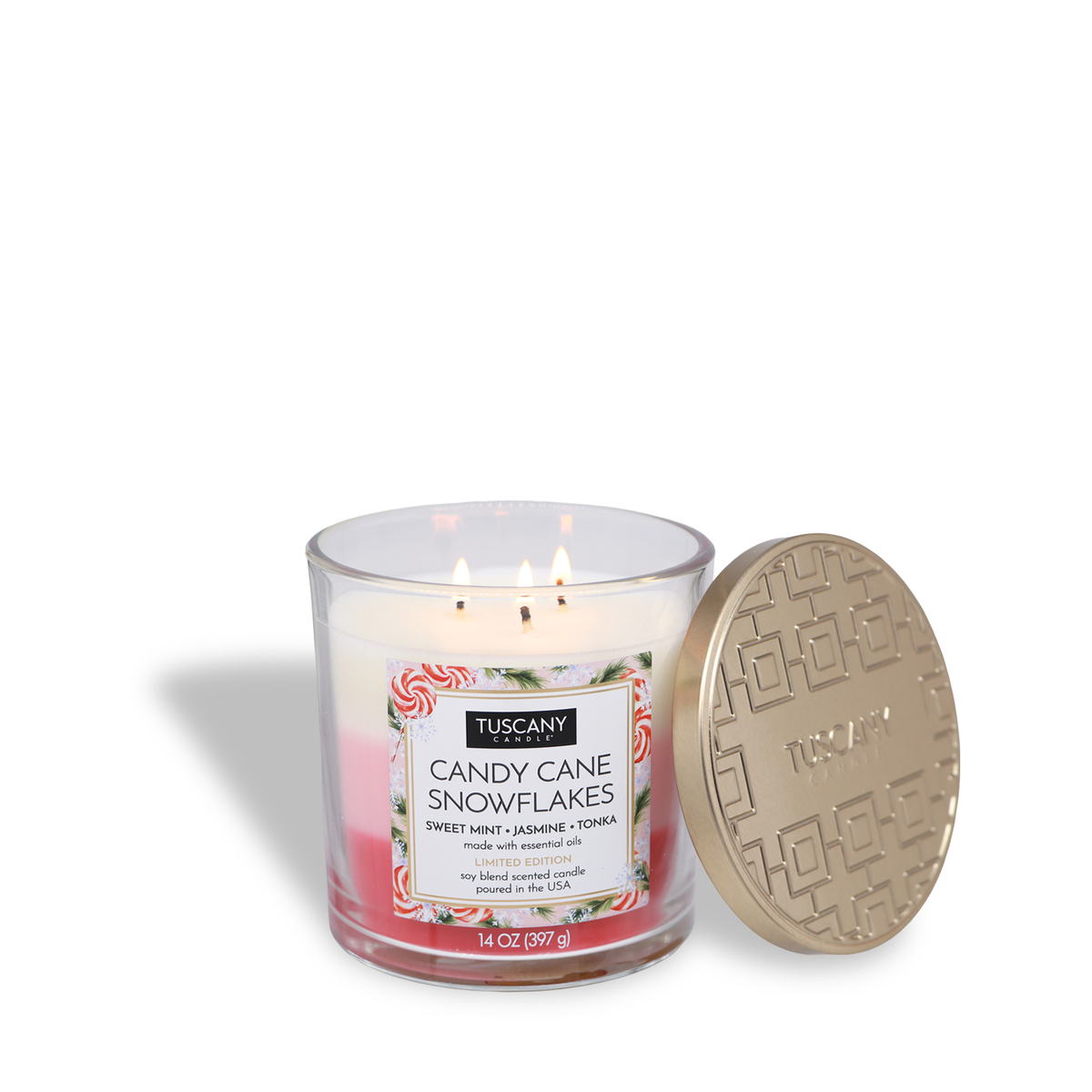 Tuscany Candle® SEASONAL Candy Cane Snowflakes: Sweet Mint & Jasmine Scented Holiday Candle (14 oz) in a clear glass jar with pink and white layered wax, next to an embossed gold lid.