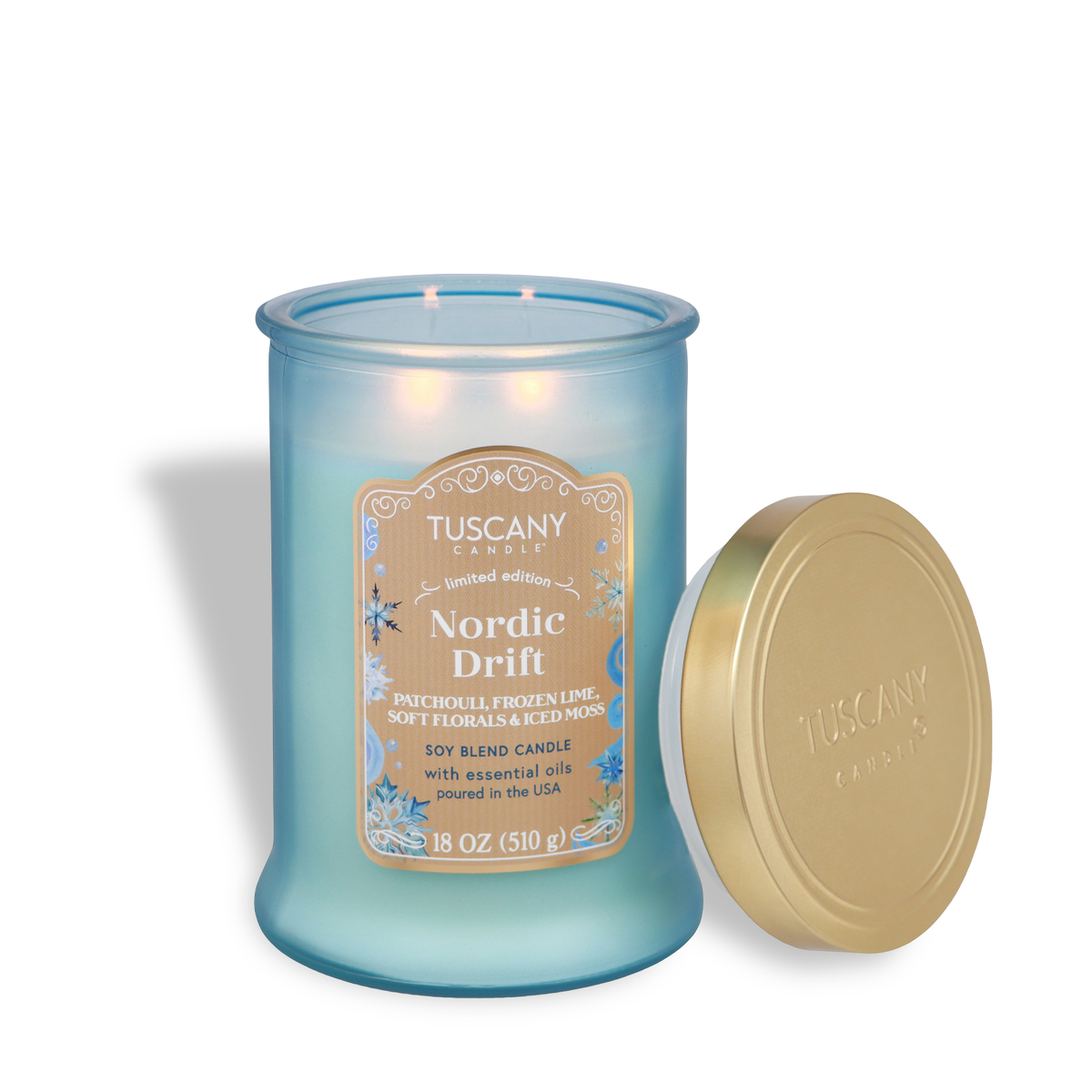 Light blue Tuscany Candle® SEASONAL Nordic Drift: Frozen Lime & Patchouli Scented Holiday Candle (18 oz) with two lit wicks and a removable gold lid.