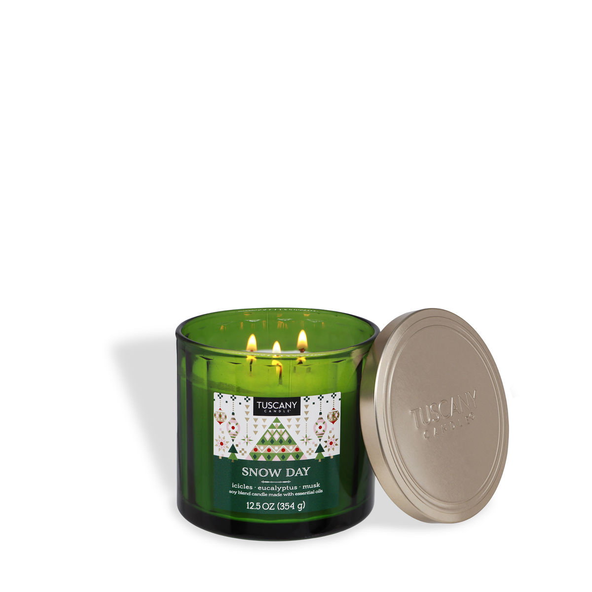 Tuscany Candle® SEASONAL Snow Day: Eucalyptus & Musk Scented Holiday Candle (12.5 oz) in a green glass jar with a Christmas tree label, beside a gold lid.