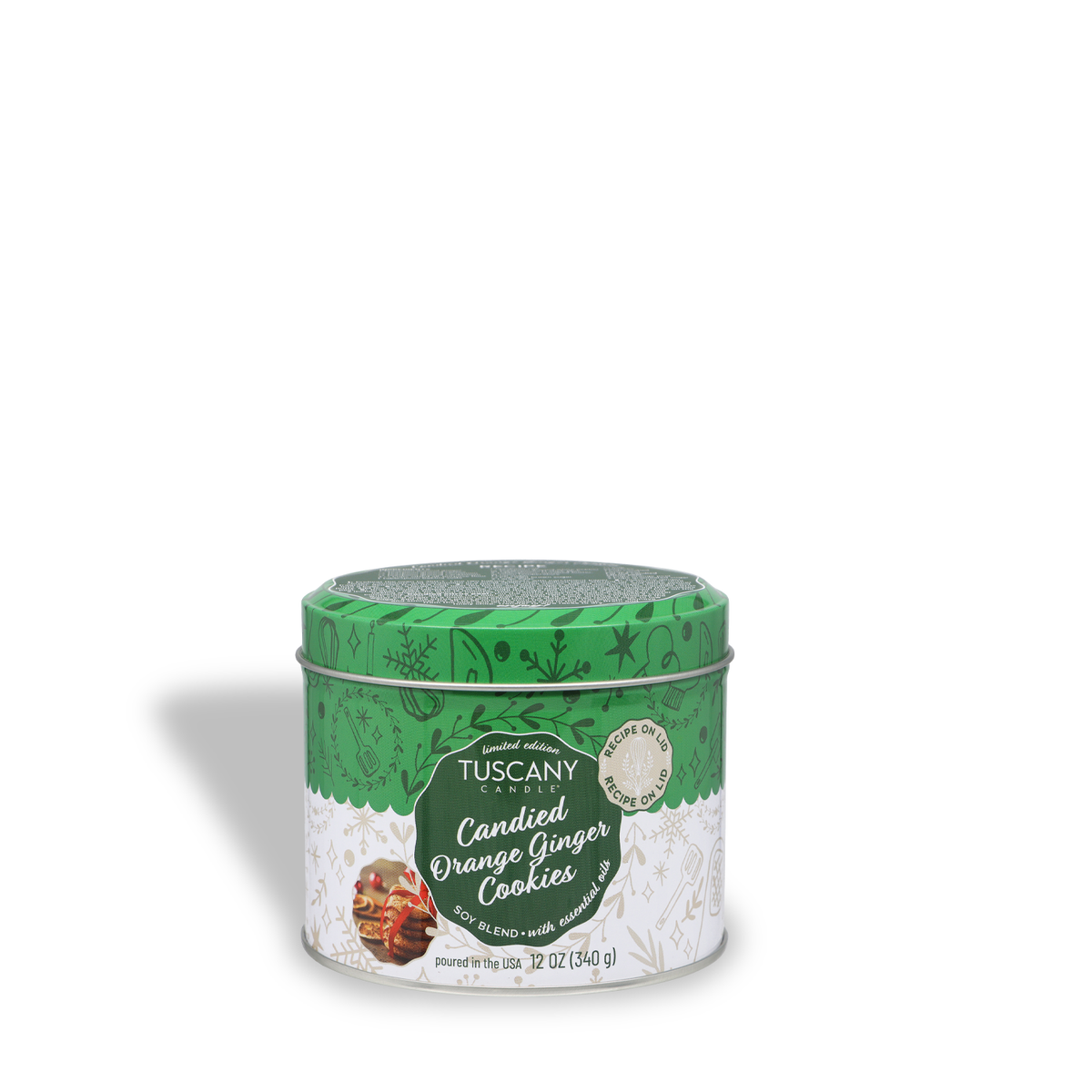A 12-ounce Tuscany Candle® SEASONAL Candied Orange Ginger Cookies Scented Holiday Candle in a decorative green metal tin with a patterned lid and a label featuring a picture of cookies.