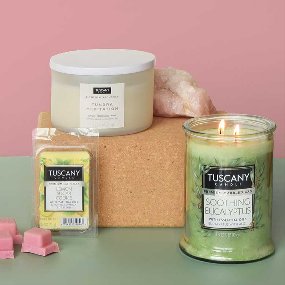 Scented candles and wax melt bars with fresh fragrances are grouped in a still life 