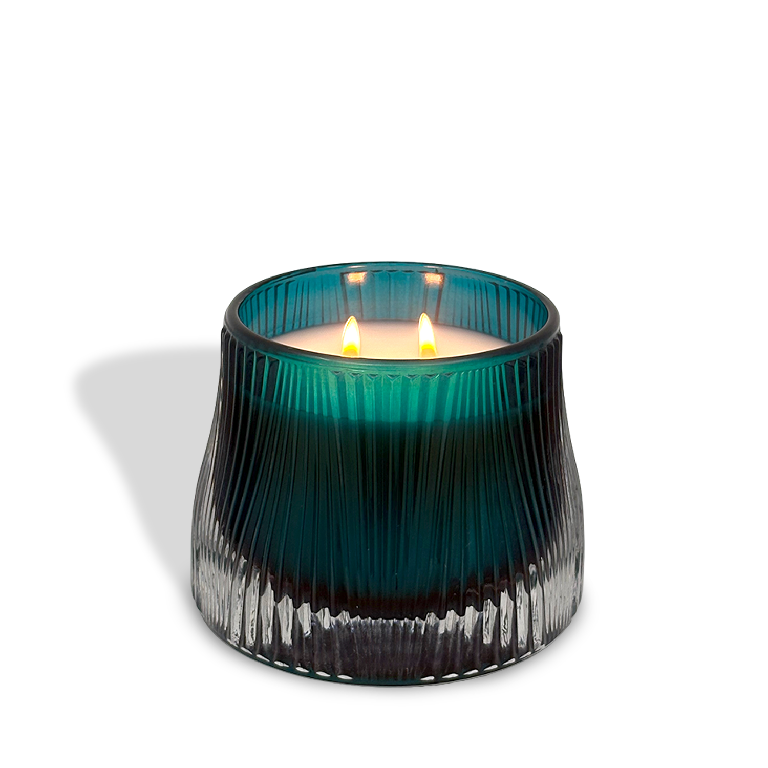 A glowing est.1951 Midnight Iris & Verbena (9oz) candle with clean-burning wax shines in a blue-green ribbed glass container on a white background, casting a soft shadow.