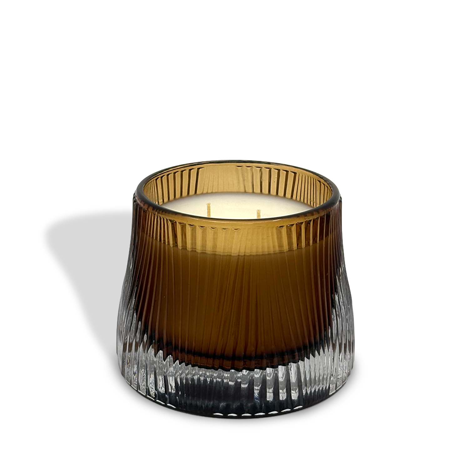 The est.1951 Sandalwood & Ginger (9oz) three-wick candle features vegan wax in a ribbed, transparent brown glass container, displayed against a white background.