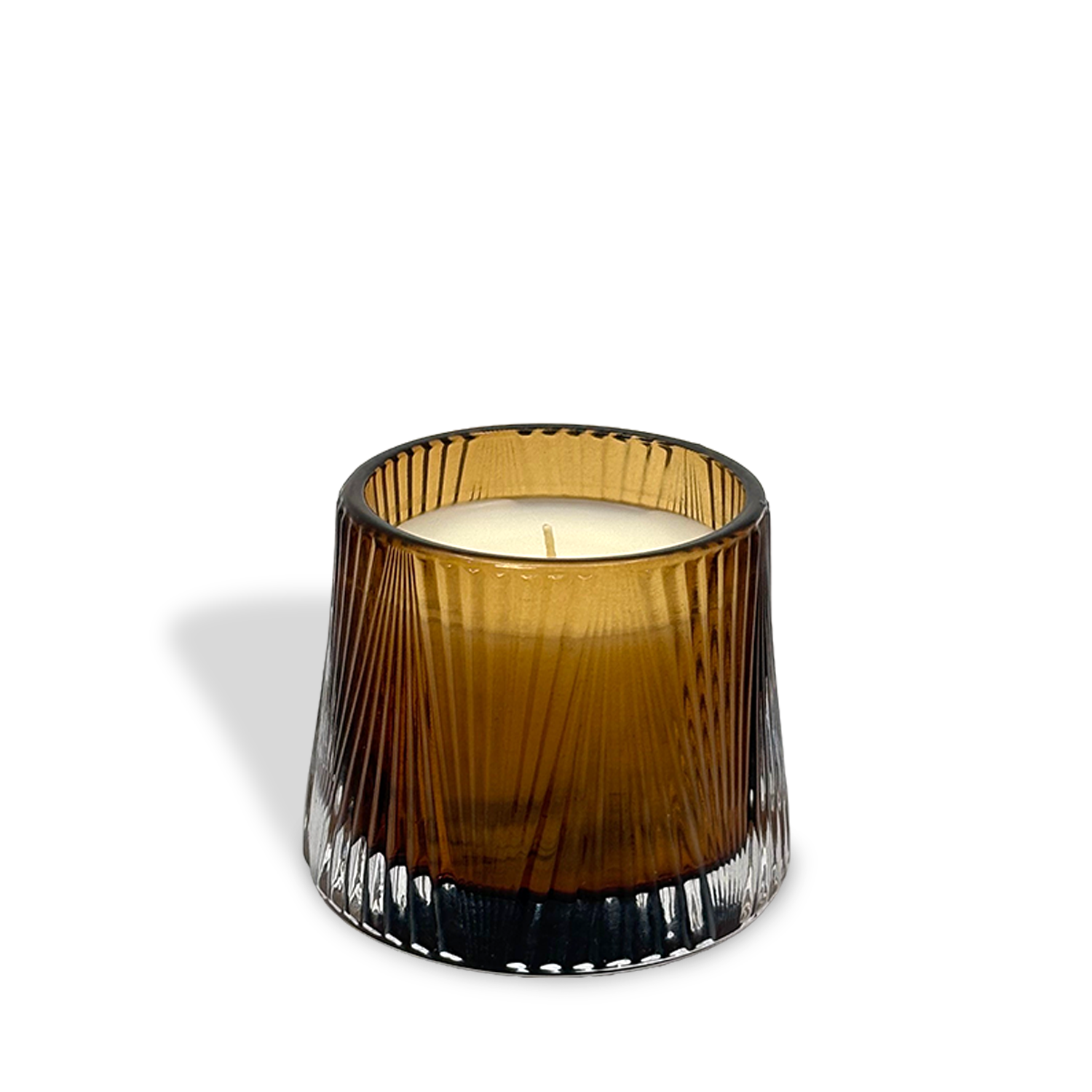 The est.1951 Sandalwood & Ginger (4oz) features a brown ribbed glass holder and white candle, casting a soft shadow on a white background.