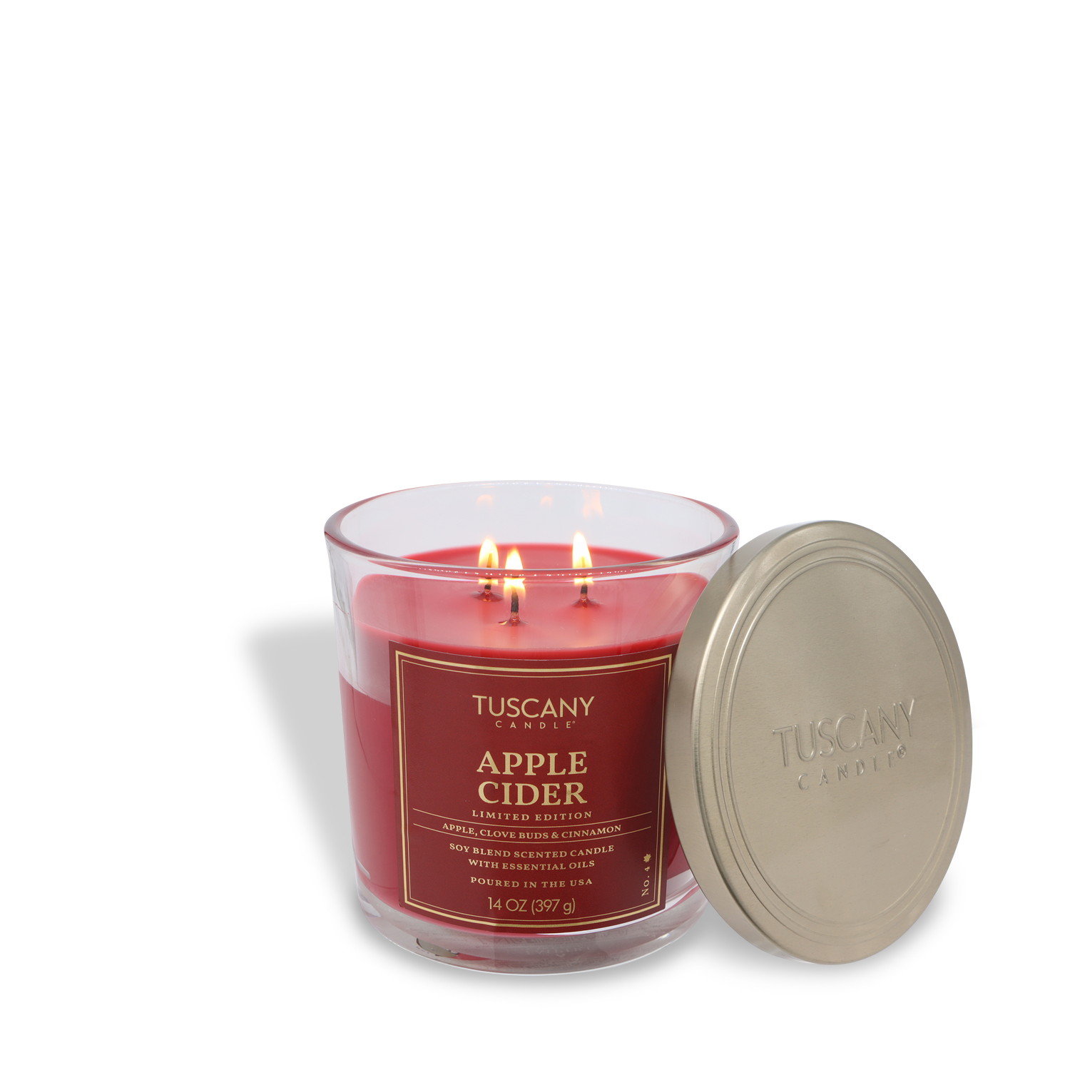 A red Tuscany Candle® SEASONAL "Apple Cider: Sugared Ginger & Cinnamon" 14 oz fall candle sits in a glass jar with an off-white lid nearby.