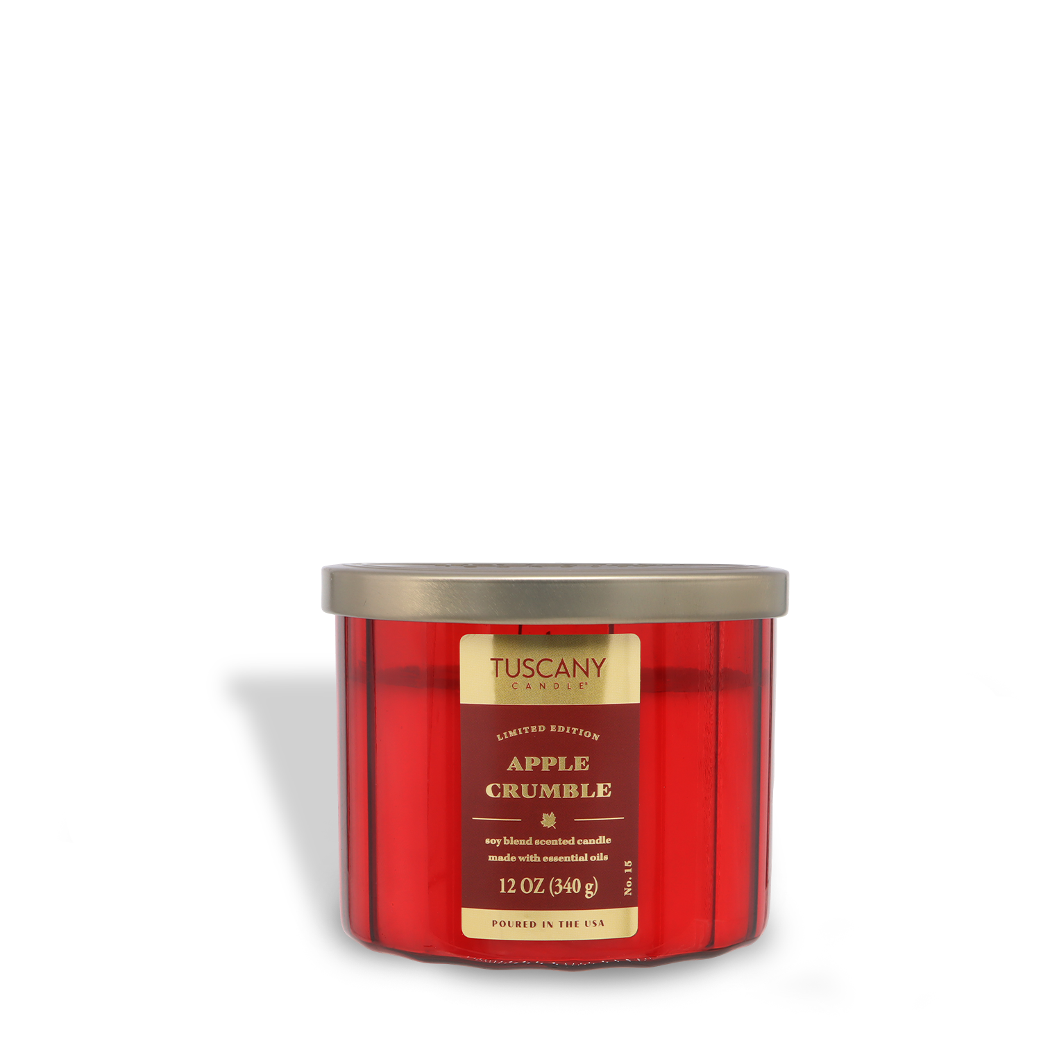 A 12 oz red glass jar candle labeled "Tuscany Candle® SEASONAL Apple Crumble: Cinnamon & Buttercream," featuring a gold lid and limited edition marking.