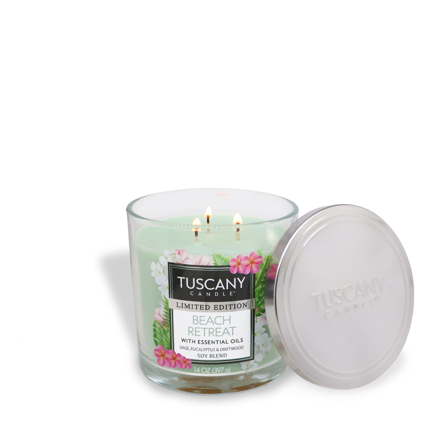 A glass jar of Tuscany Candle® SEASONAL Beach Retreat: Eucalyptus & Sage Scented Summer Candle (14 oz), three wicks lit, silver lid beside it. The light green candle has a floral label, evoking a relaxing seaside getaway.