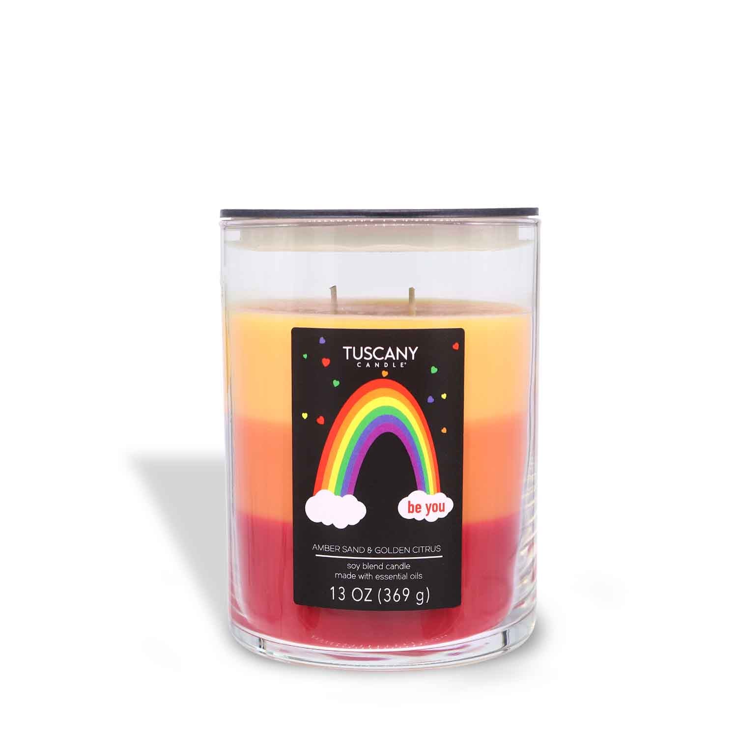 A Be You Scented Jar Candle (13 oz) from the Pride collection with a rainbow on it, made by Tuscany Candle® SEASONAL.