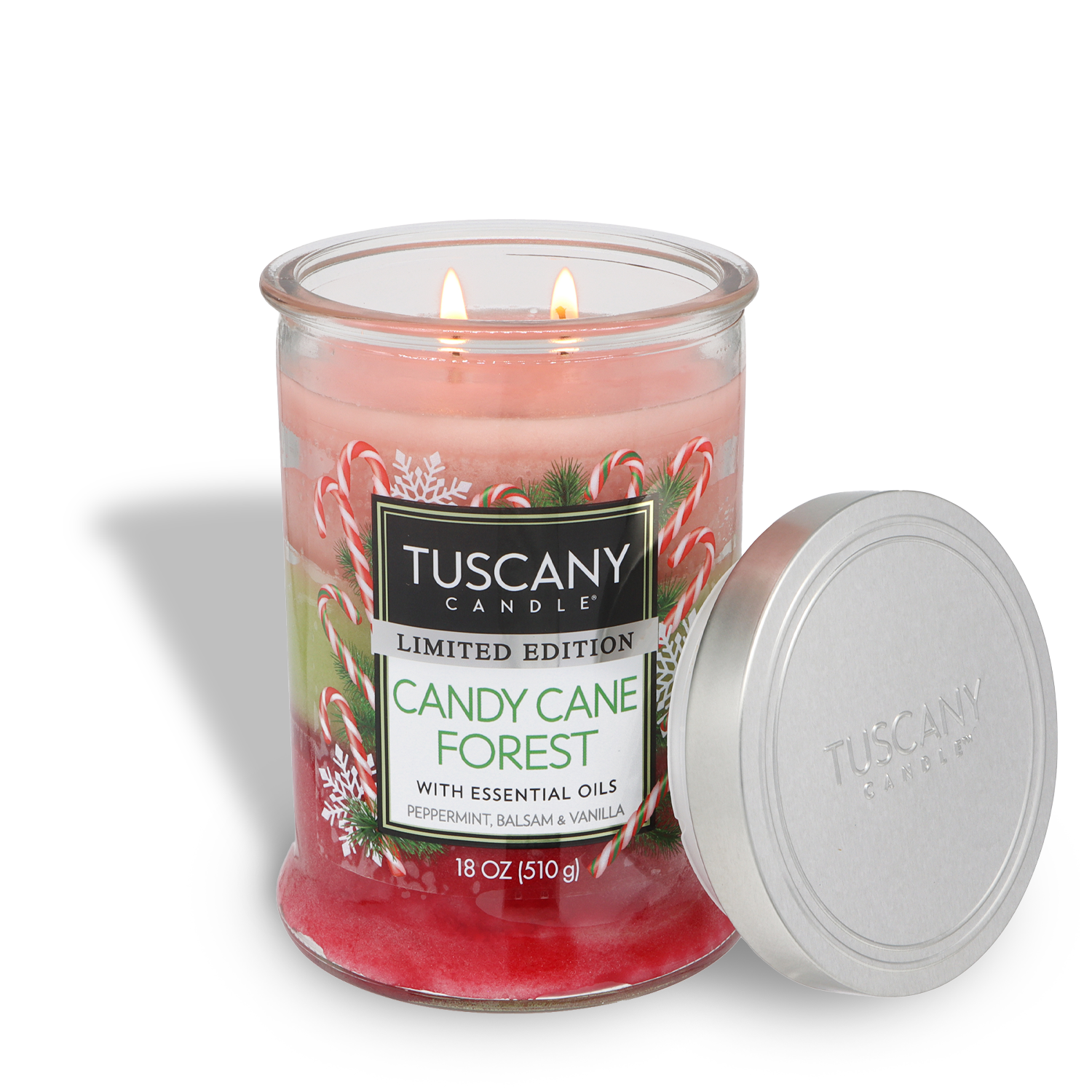 A lit Tuscany Candle® SEASONAL "Candy Cane Forest: Peppermint & Balsam Scented Holiday Candle" (18 oz) jar with the lid beside it, featuring peppermint, balsam, and vanilla notes.