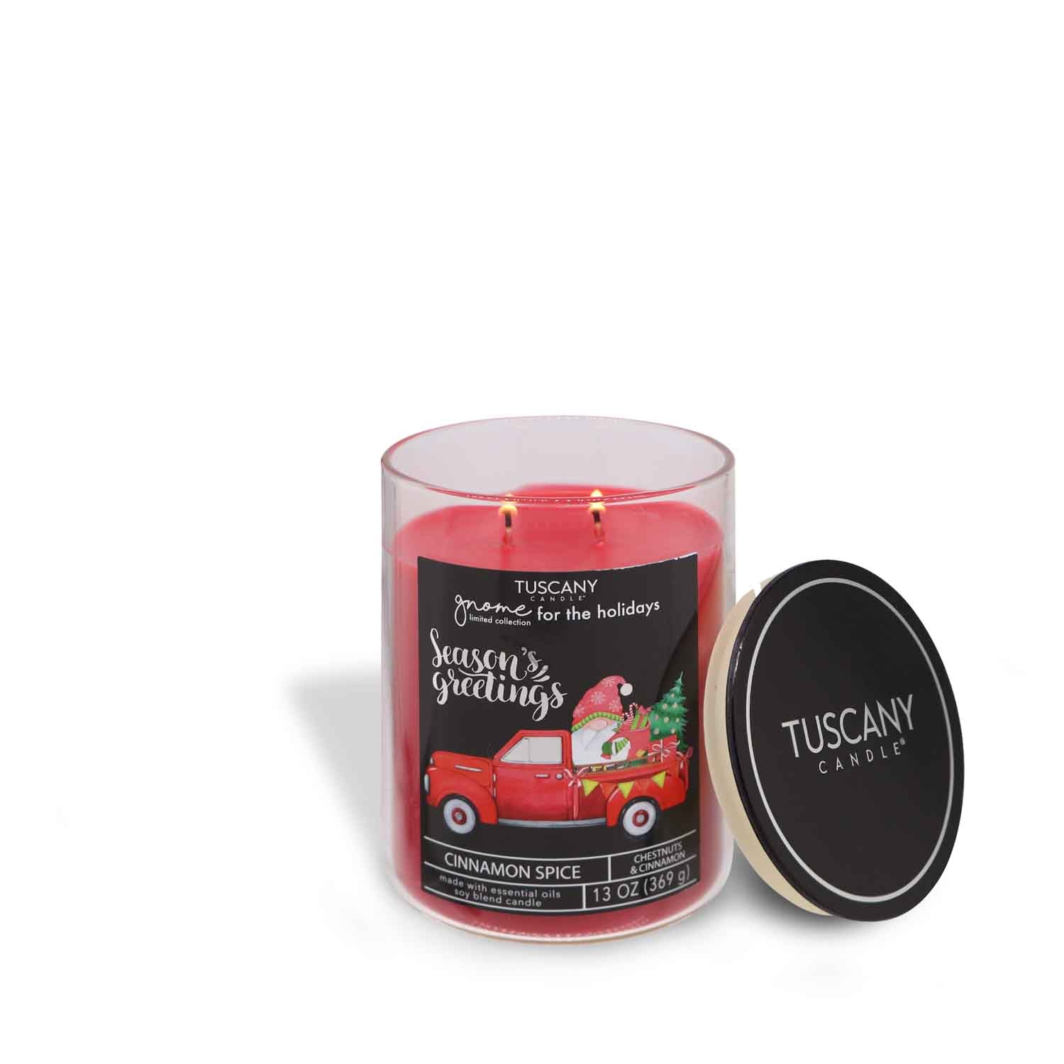Festive red-waxed Cinnamon Spice candle adorned with playful holiday gnomes on its label, set in sharp contrast to a white backdrop.