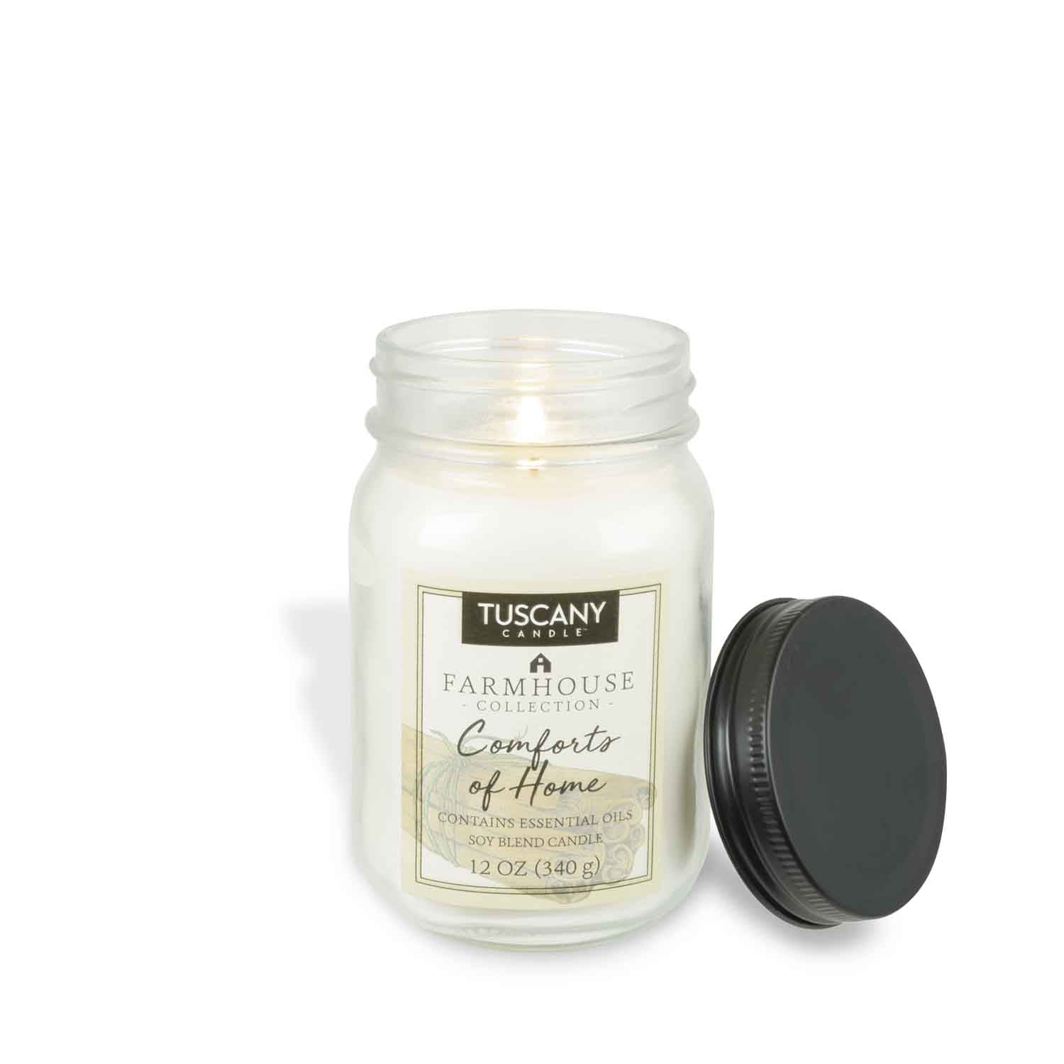 A white jar with a black lid containing Comforts of Home Scented Jar Candle (12 oz) – Farmhouse Collection by Tuscany Candle® EVD containing nutmeg.